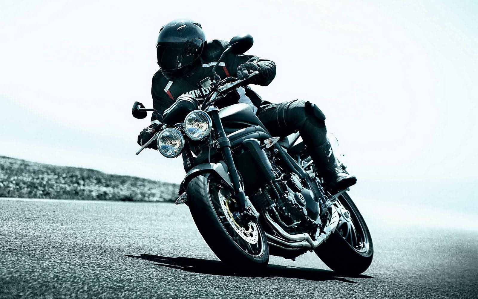 Black Motorcycle In Cornering Mode Background