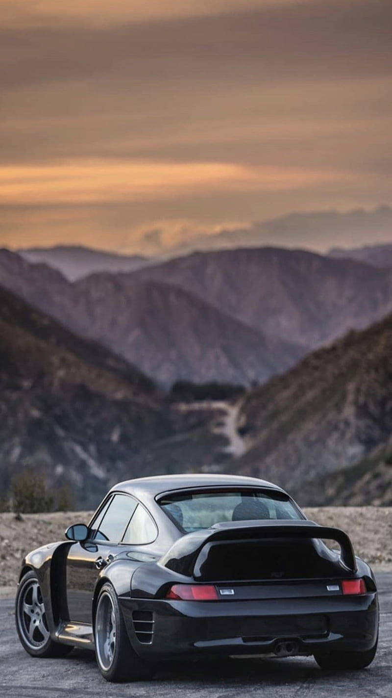 Black Porsche 911 Overlooking The Mountains