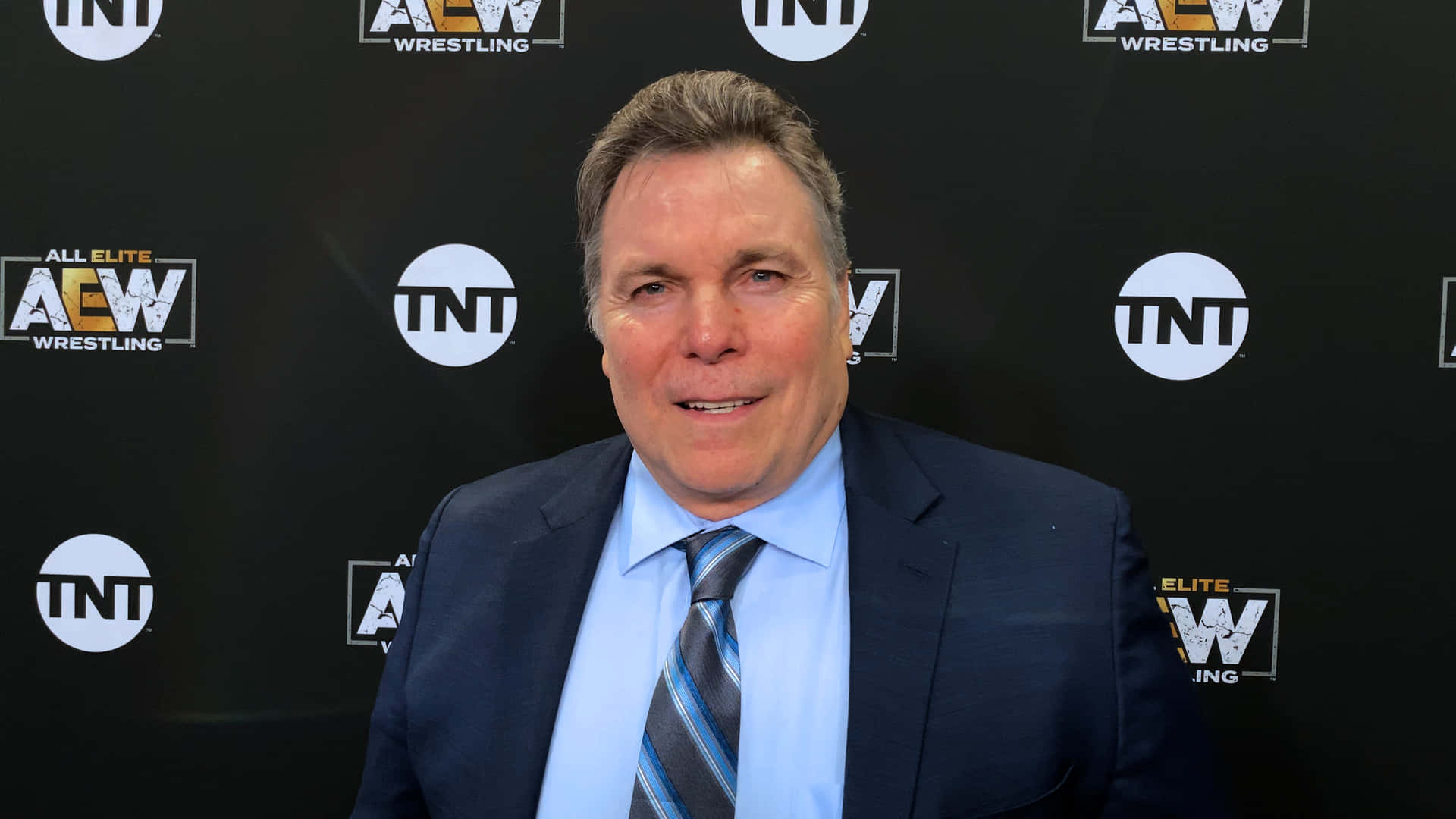 Black Suit Blue Polo Lanny Poffo Background