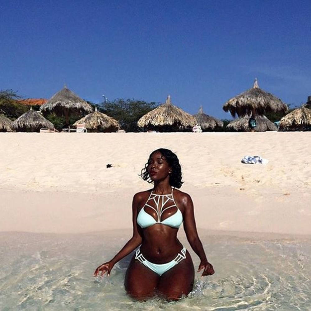 Black Woman In Bikini Huts Beach Background