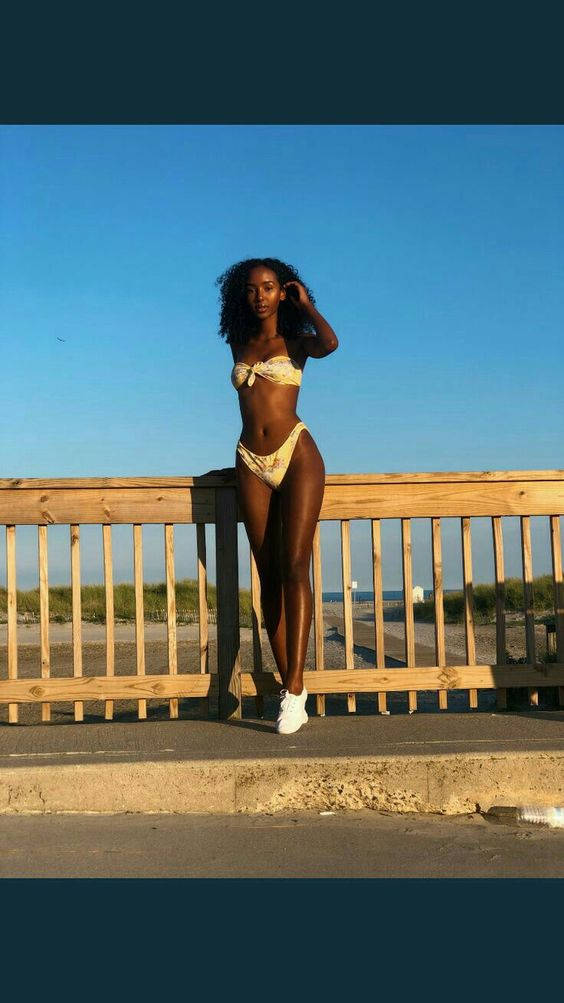 Black Woman In Bikini Railings Background