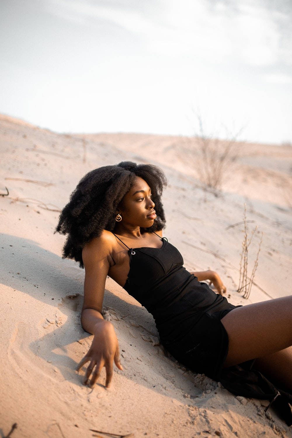 Black Woman Model On White Sand Background