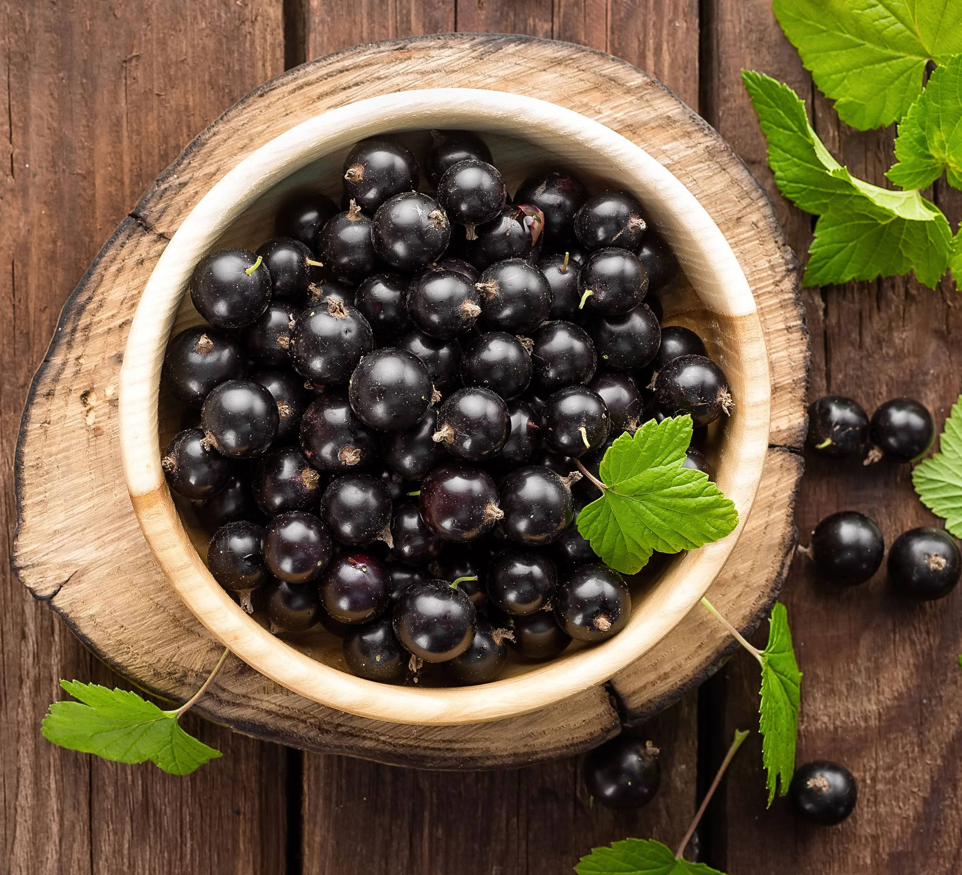 Blackcurrant In A Wooden Bowl Background