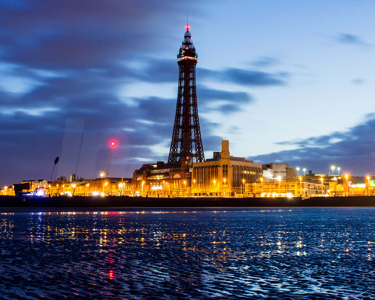 Blackpool Tower With Yellow City Lights Down Below Background