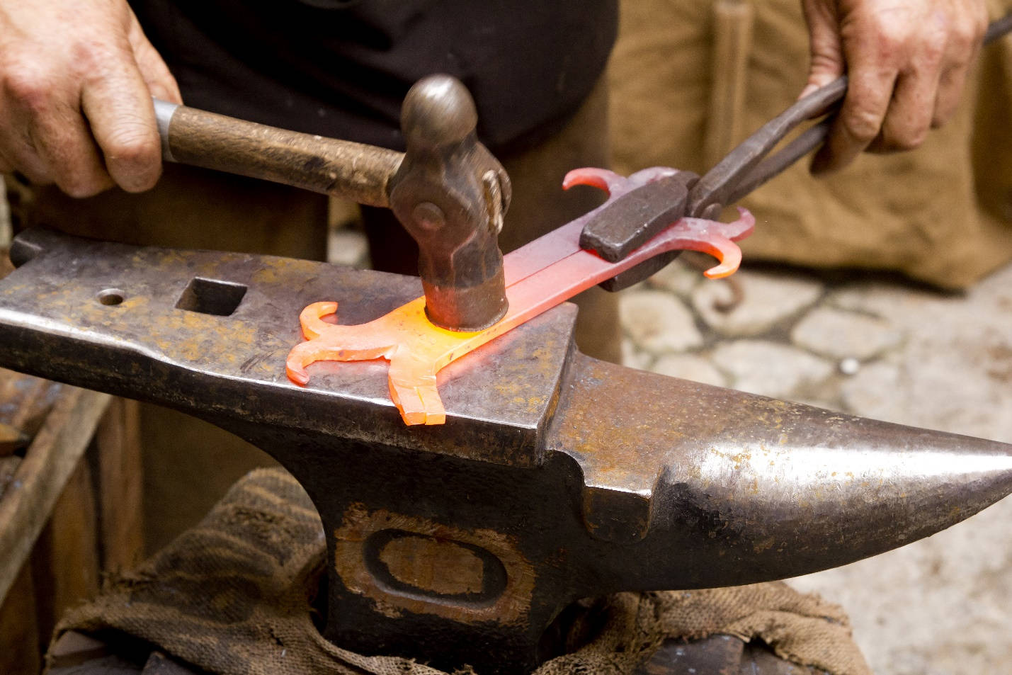 Blacksmith Forging Iron Metal With Tools Background