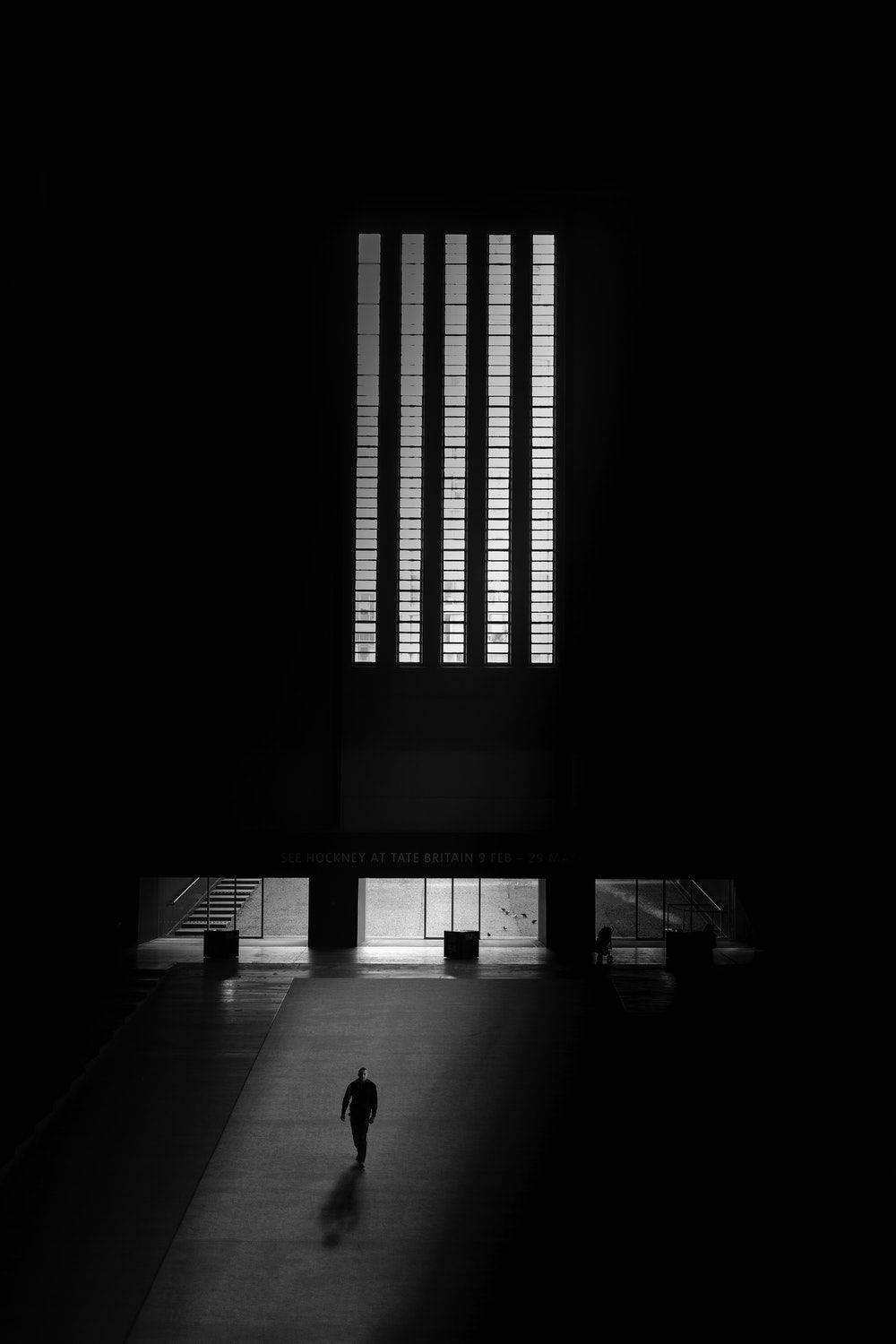 Blank And White Man Entering Building Background