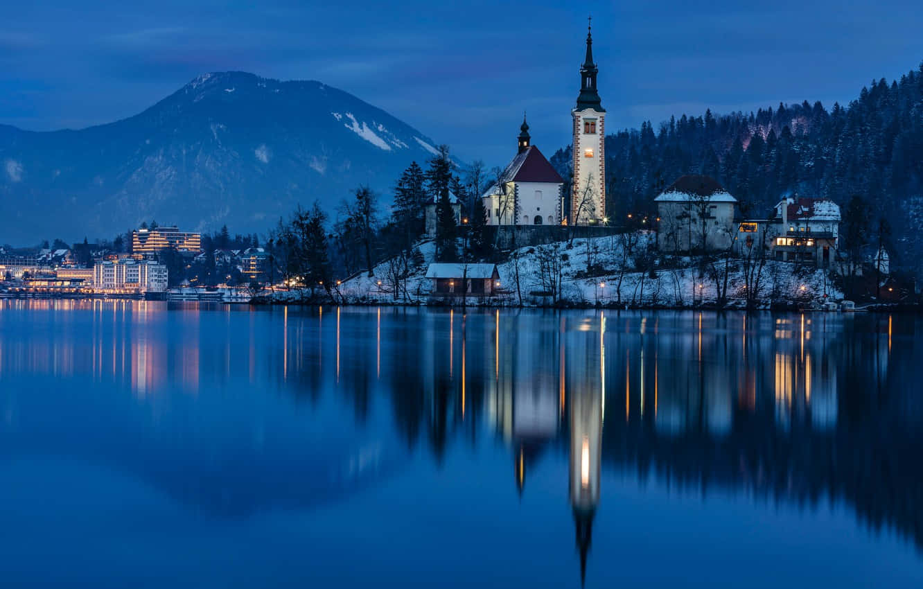Bled Castle Mirrored In Lake Bled At Dusk