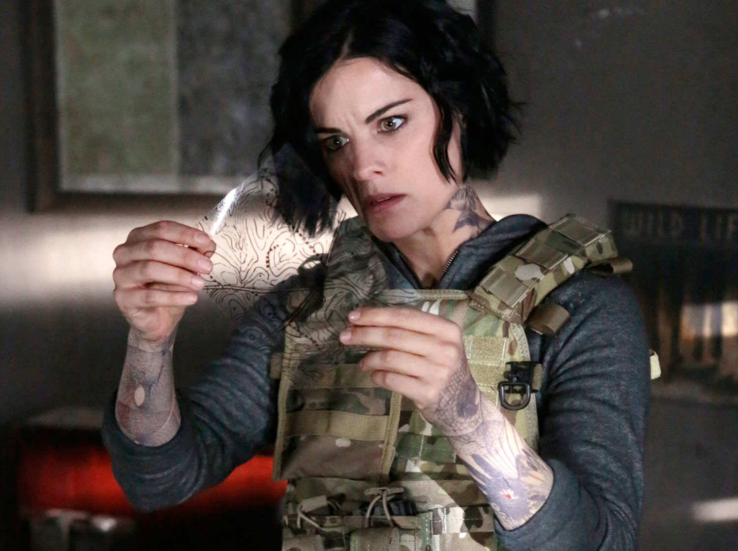 Blindspot Jane Doe Pondering On A Clue Background