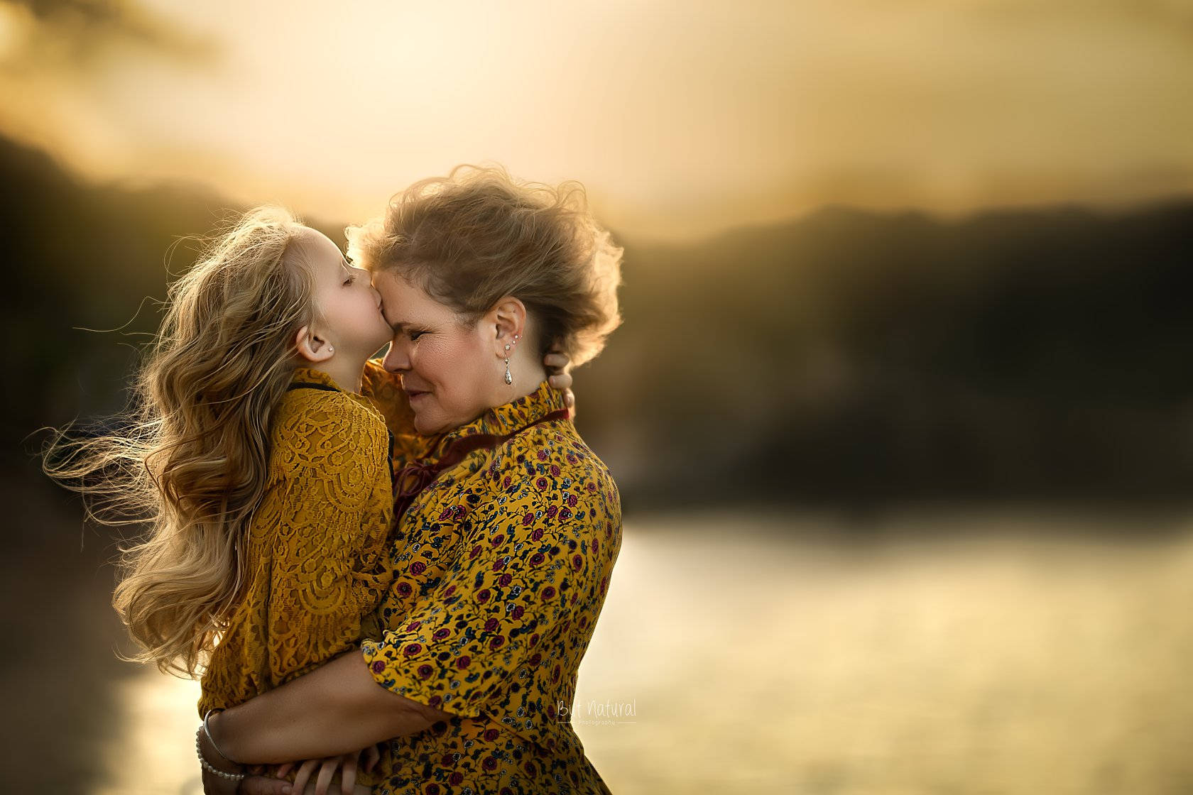 Blonde Mother And Daughter In Yellow Background