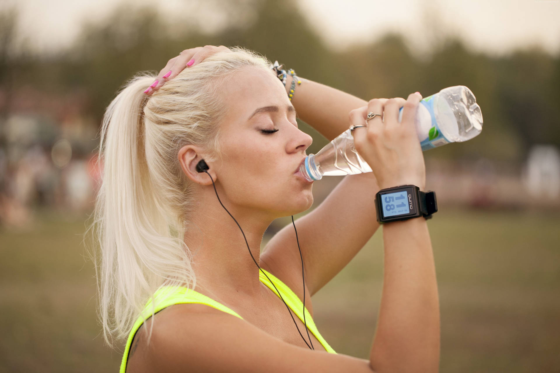 Blonde Woman Drinking Water From Bottle