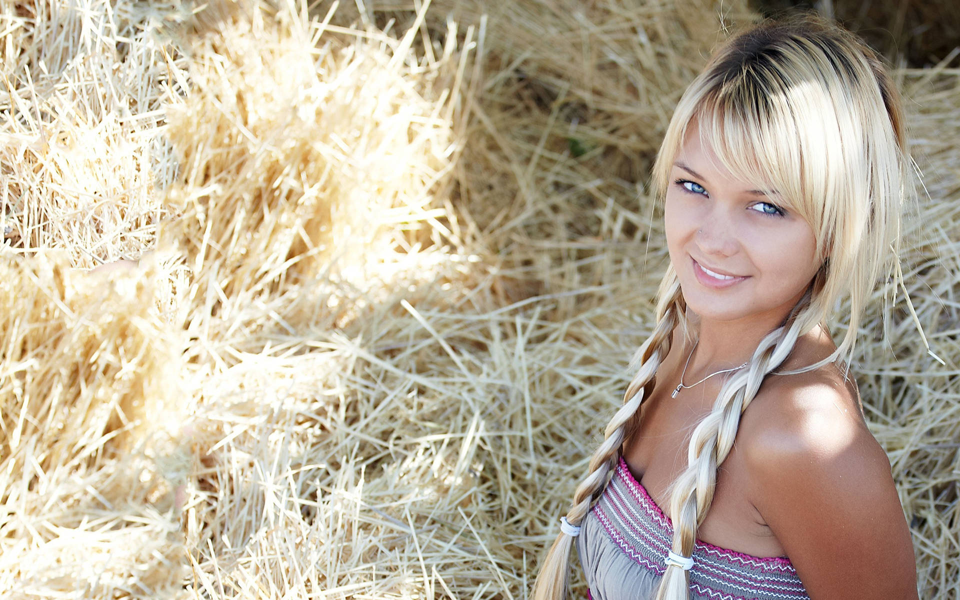 Blonde Woman On A Bed Of Hay Background