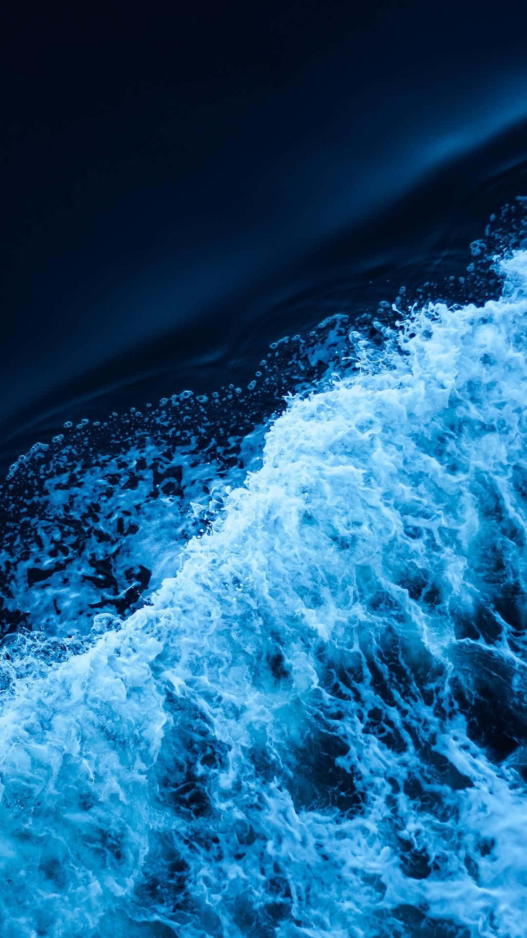 Blue Amoled Waves In Shore Background