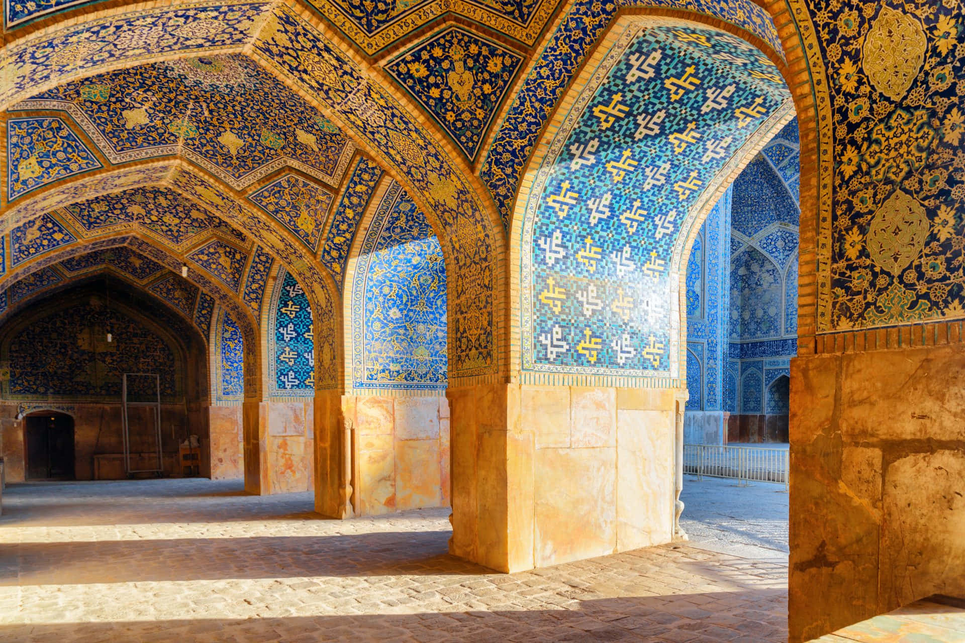 Blue And Yellow Schemes Inside Shah Mosque Background