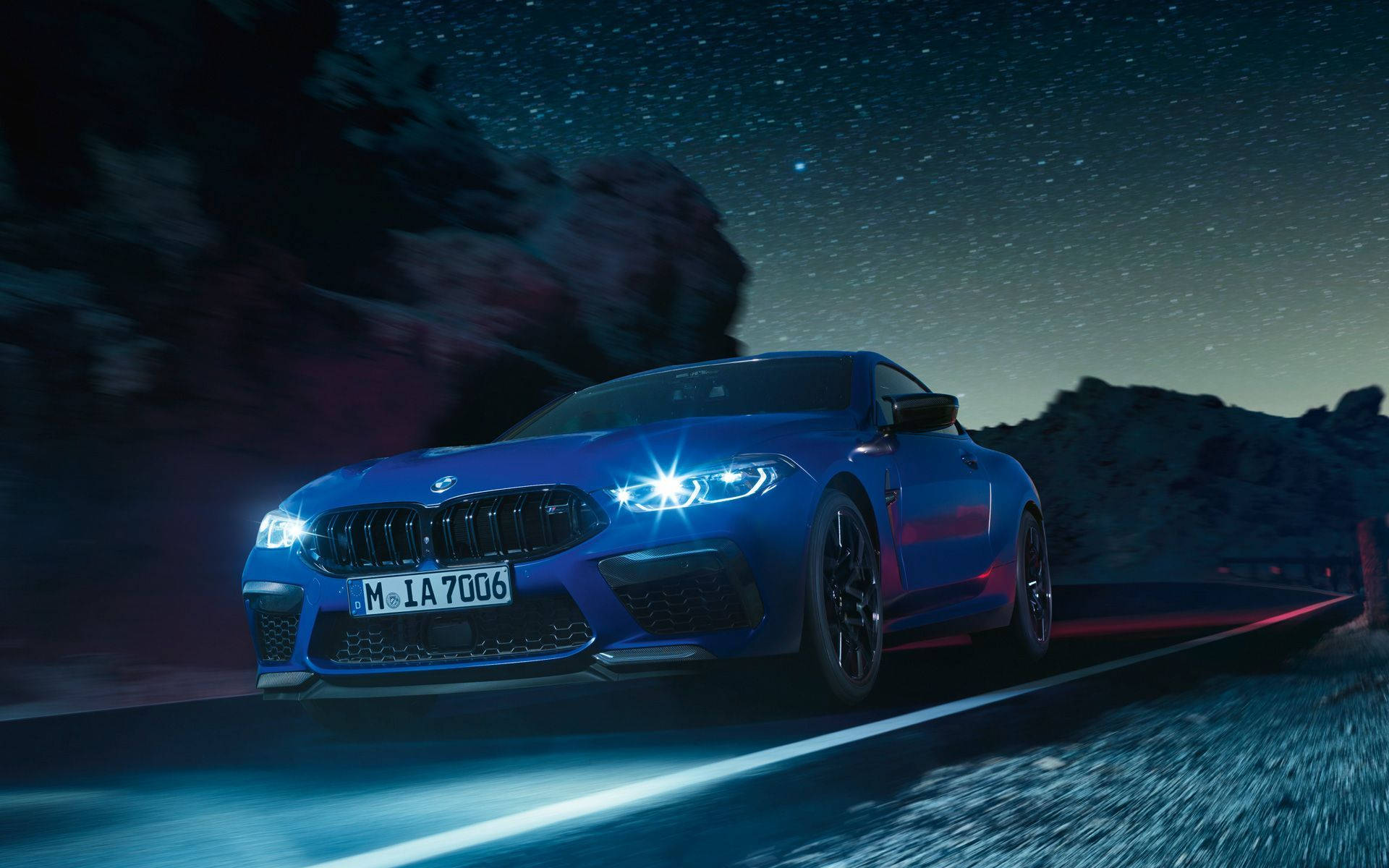 Blue Bmw Driving At Night Background