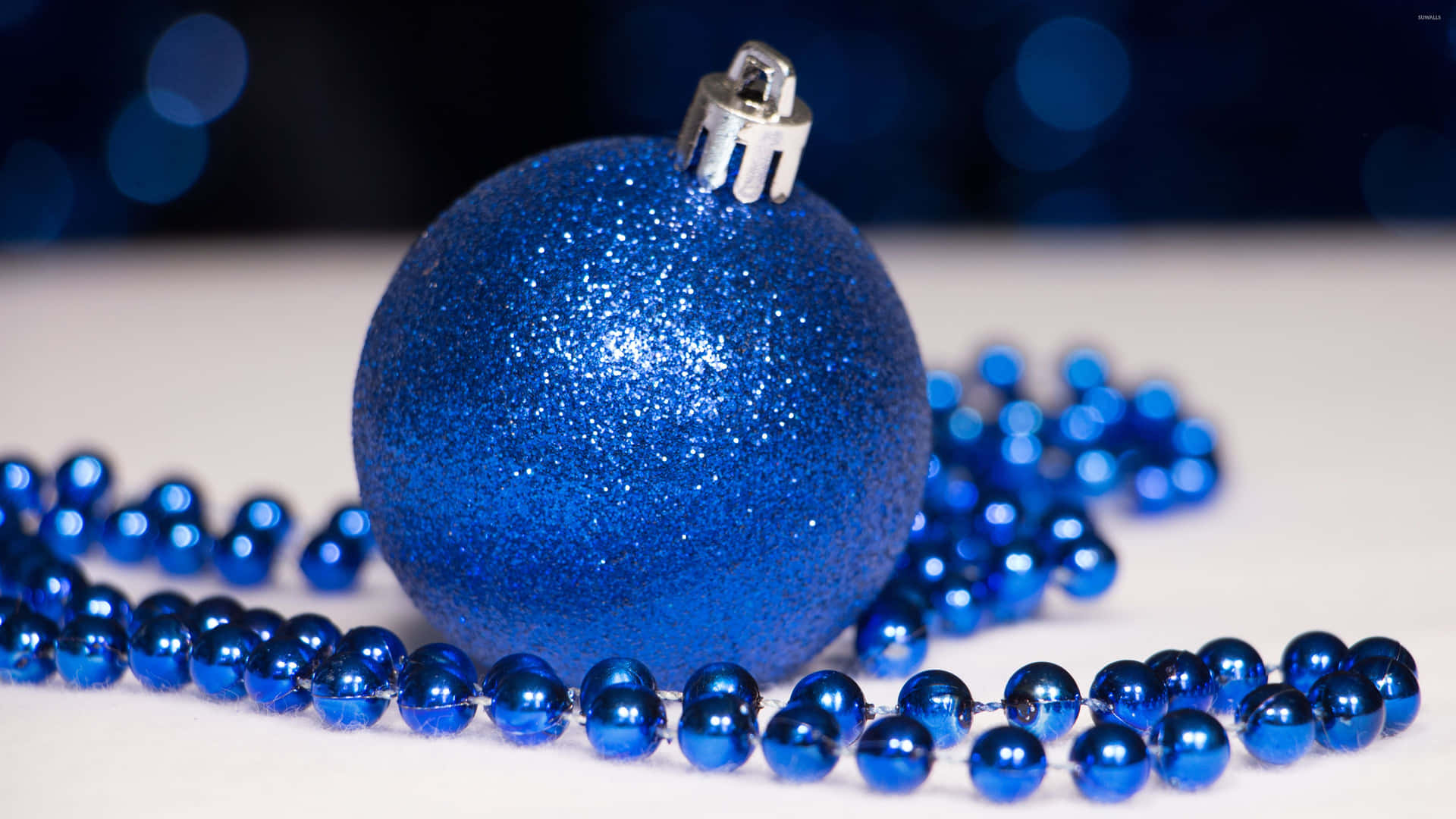Blue Christmas Ornaments With Beads On A Table