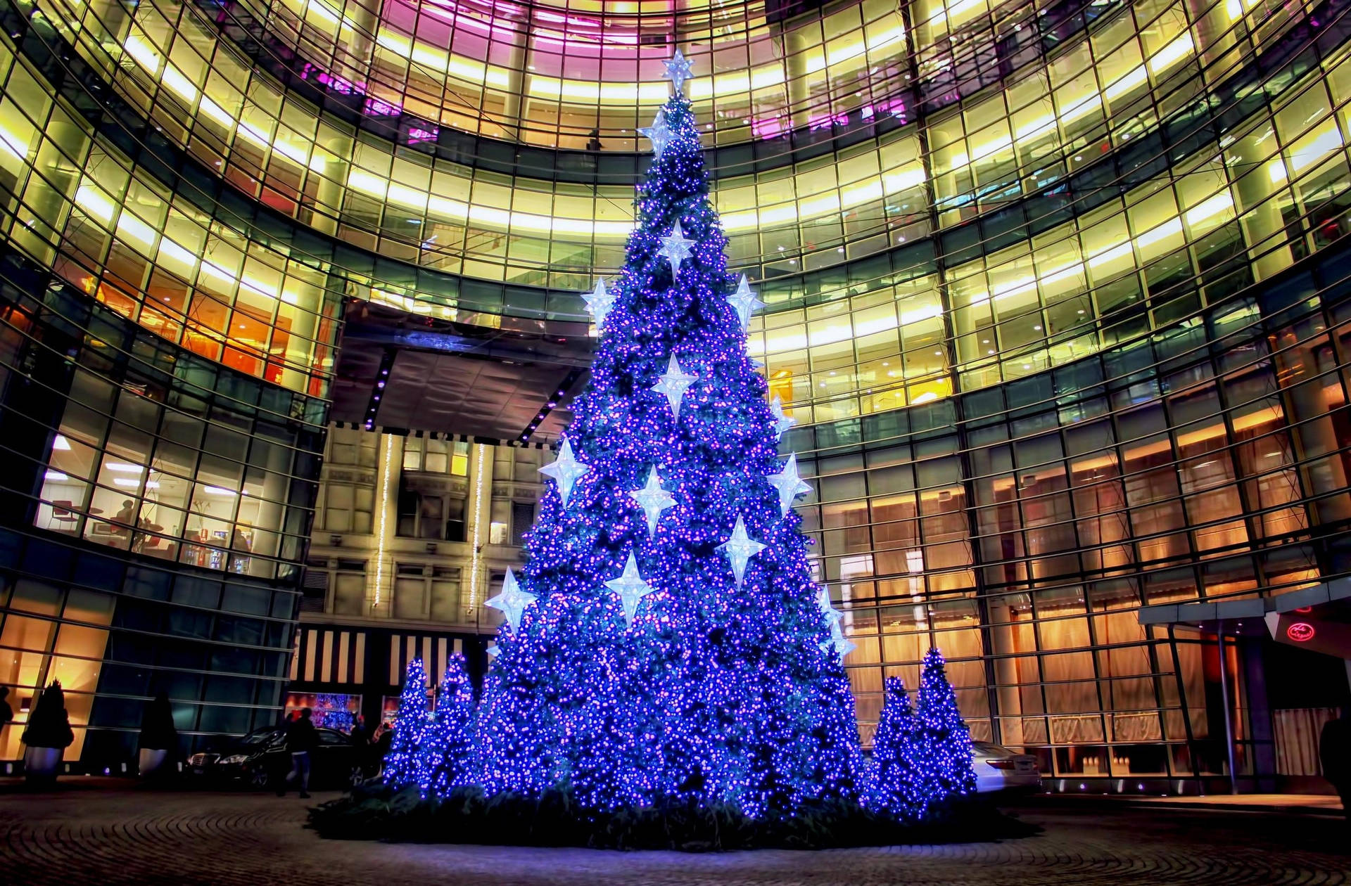 Blue Christmas Tree At City Building Background