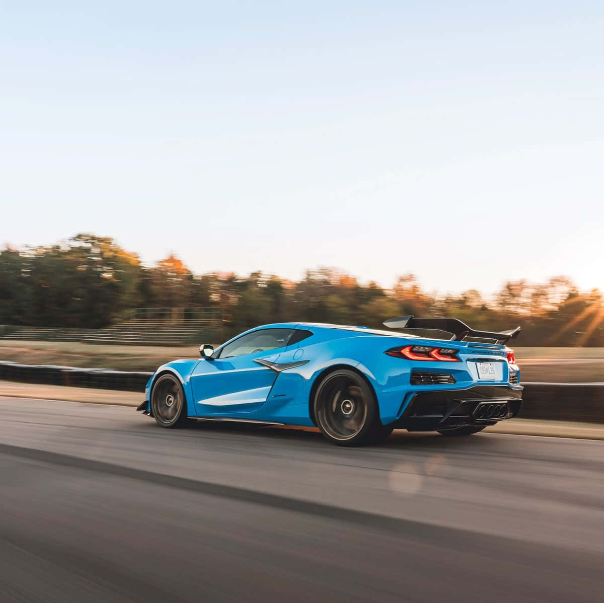 Blue Corvette C8 Speedingon Highway Background