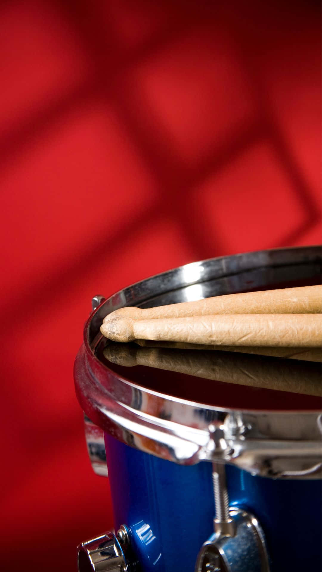 Blue Drumwith Drumsticks Red Background