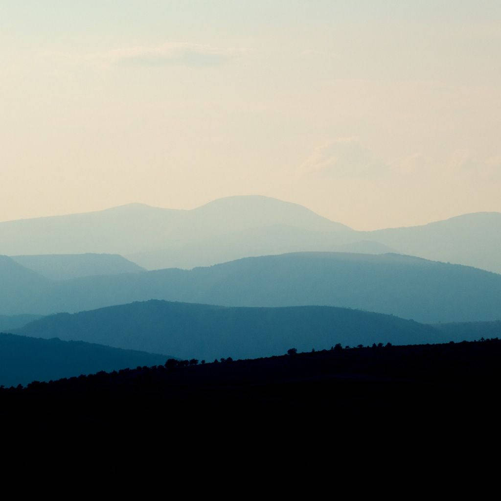 Blue Fade Mountain Range Background