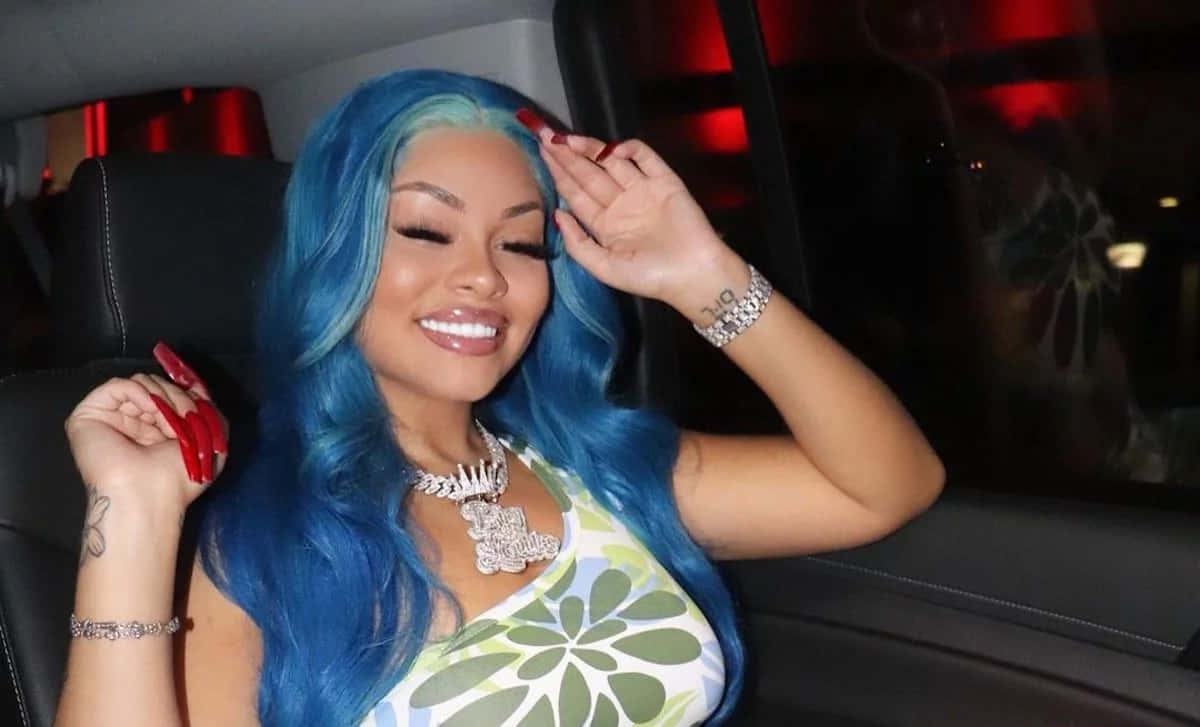 Blue Haired Woman Smilingin Car Background