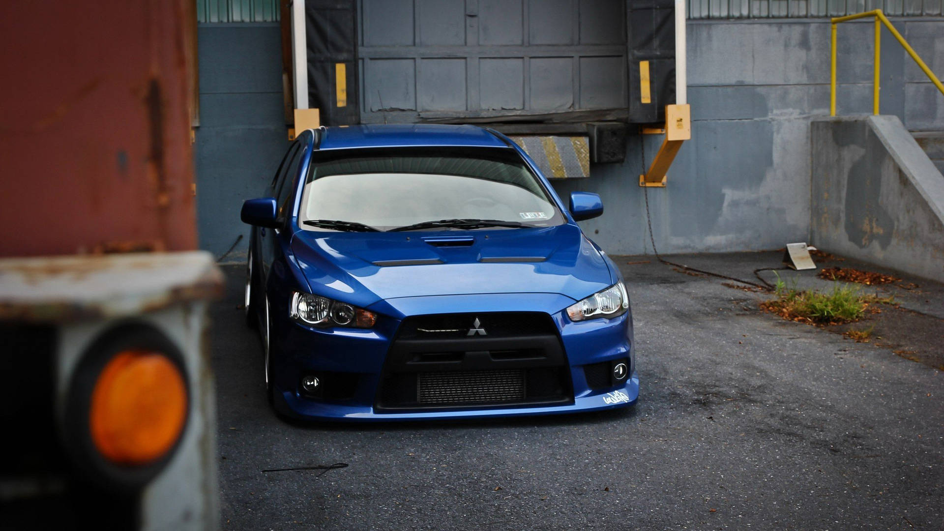 Blue Jdm Mitsubishi Evo X In Garage Background