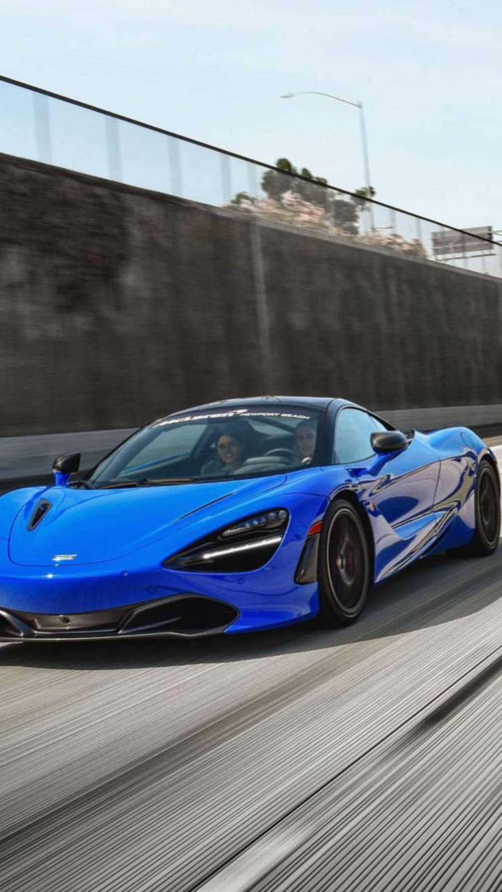 Blue Mclaren 720s Running On Road Phone Background