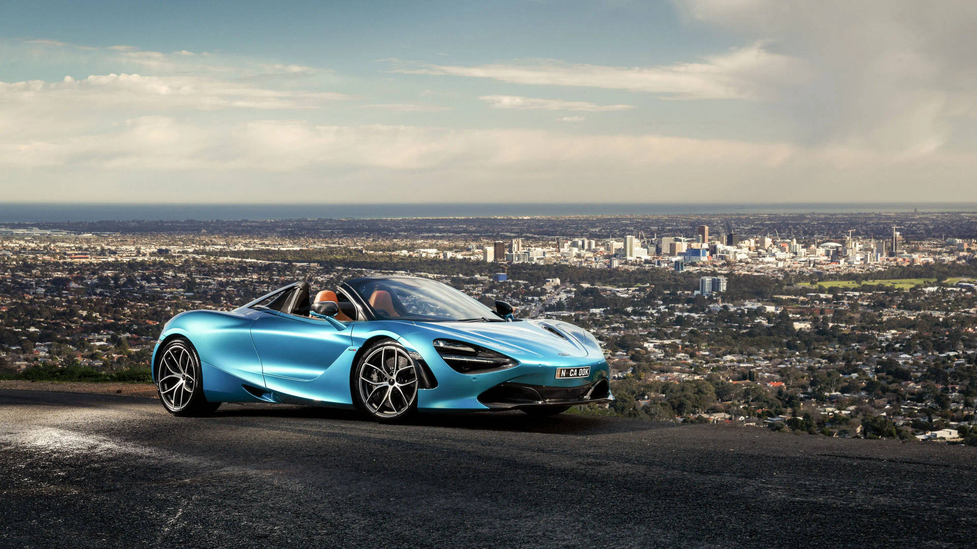 Blue Mclaren Spyder Near City Background