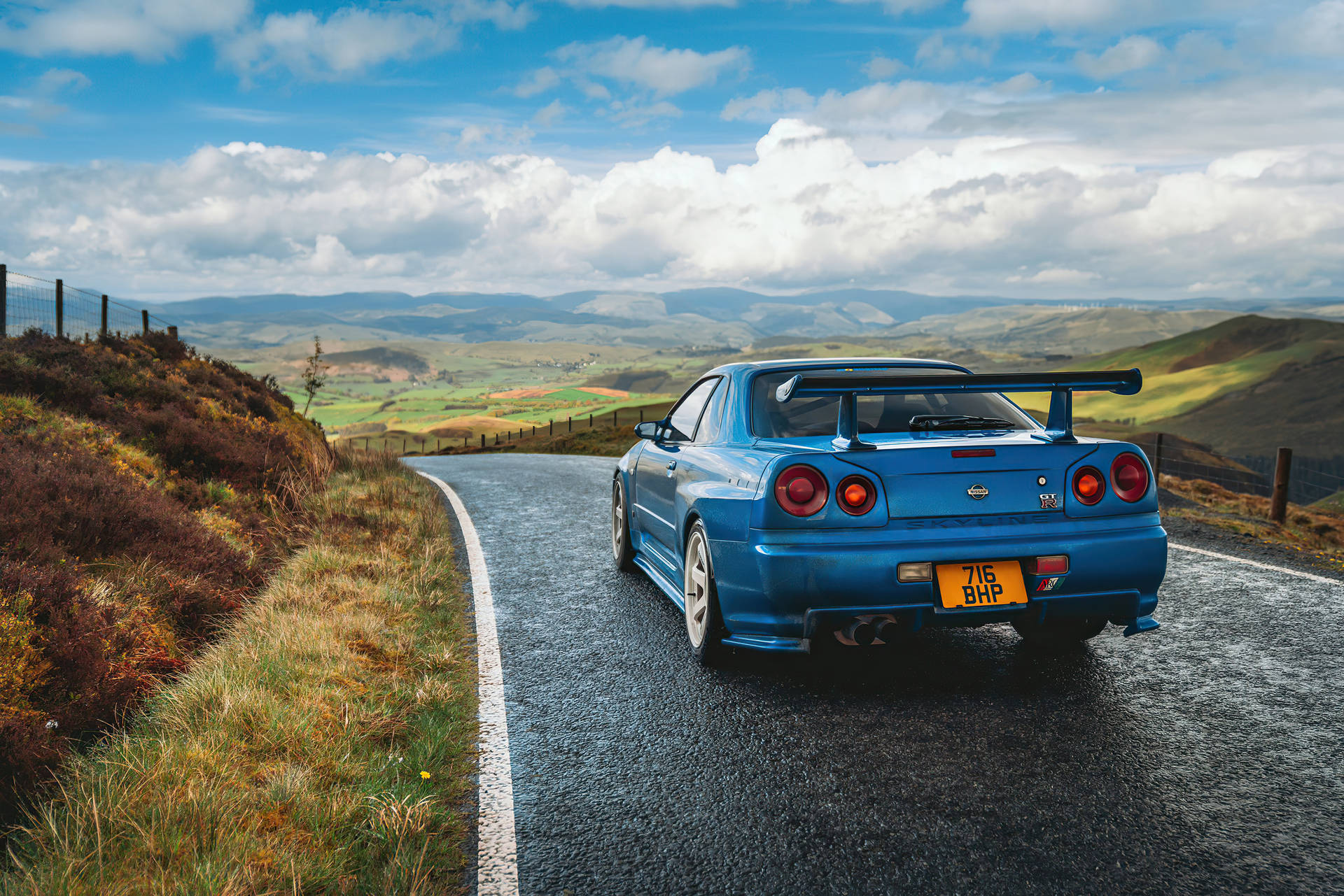 Blue Nissan Skyline Gtr R34 At Hills Background