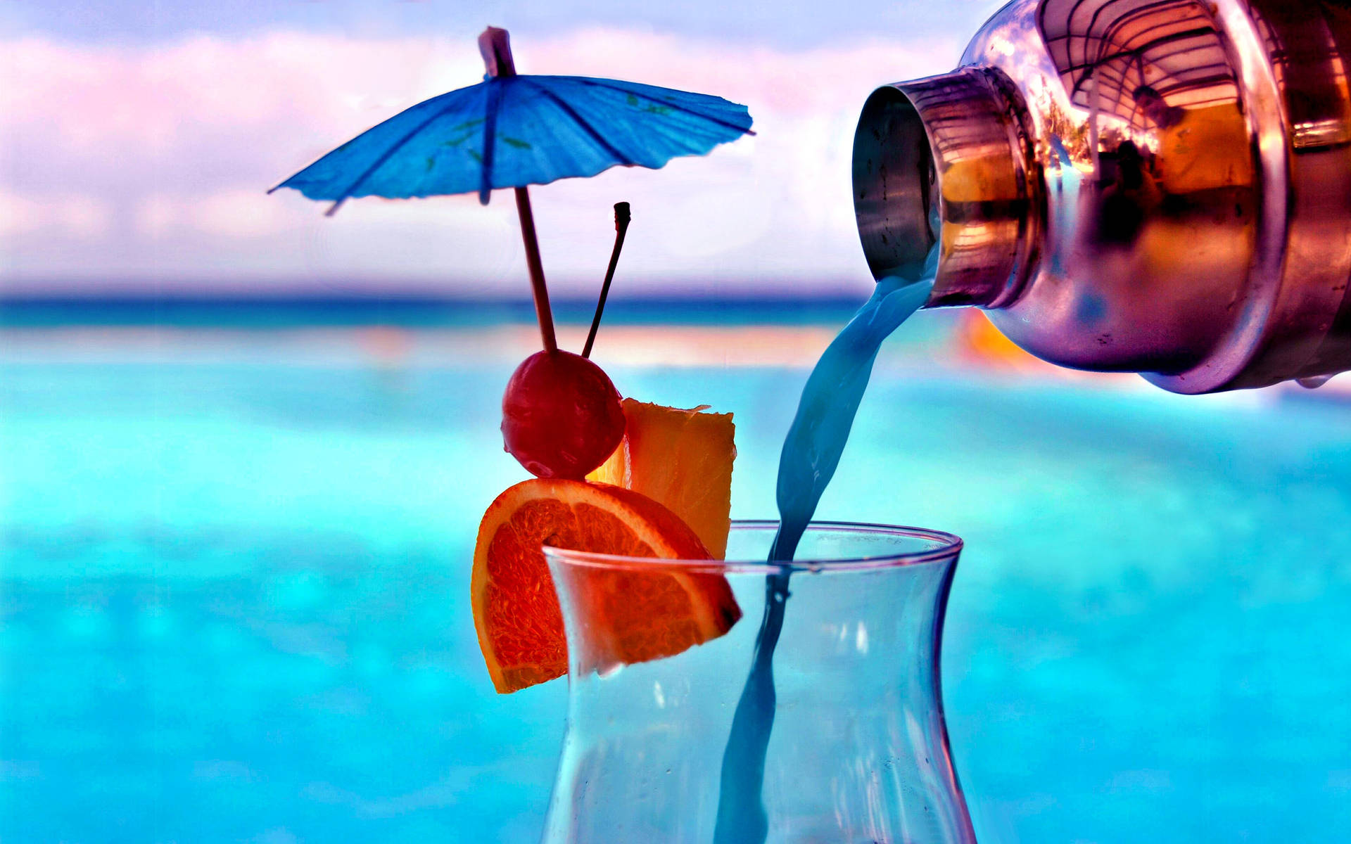 Blue Tropical Drink Pouring In A Glass Background