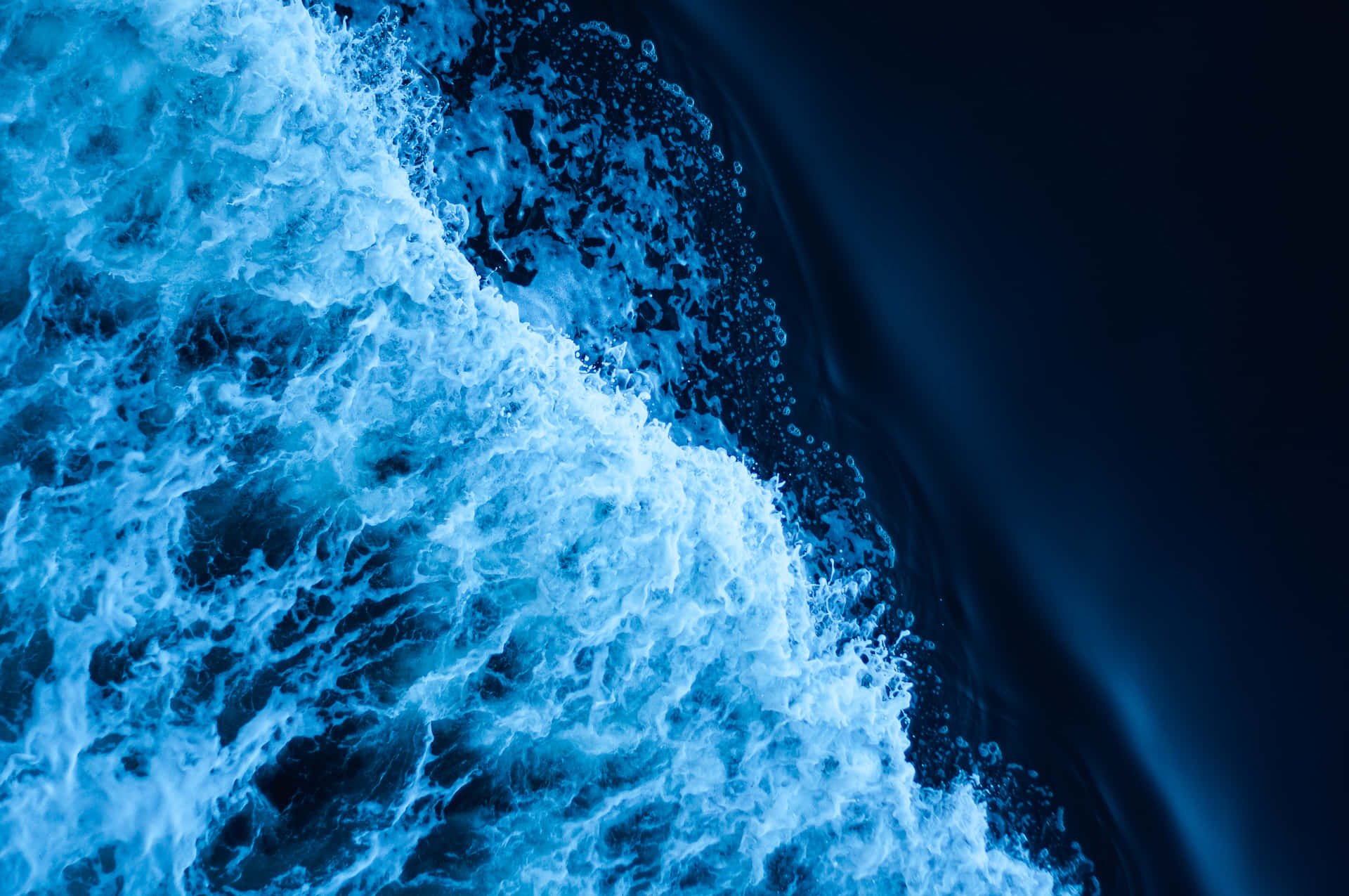 Blue Water Crashing On The Ocean Background