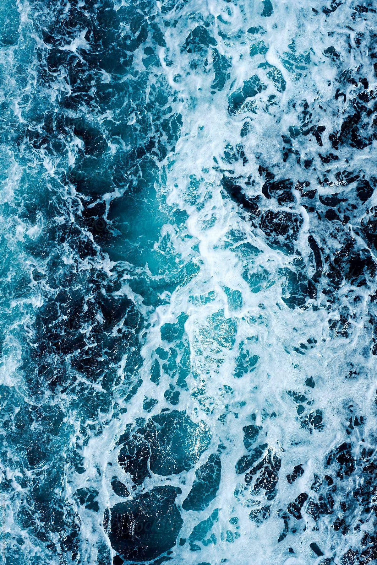 Blue Water With White Foam On The Surface Background
