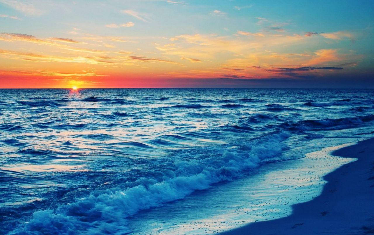 Blue Waves On Beach Sunset Background