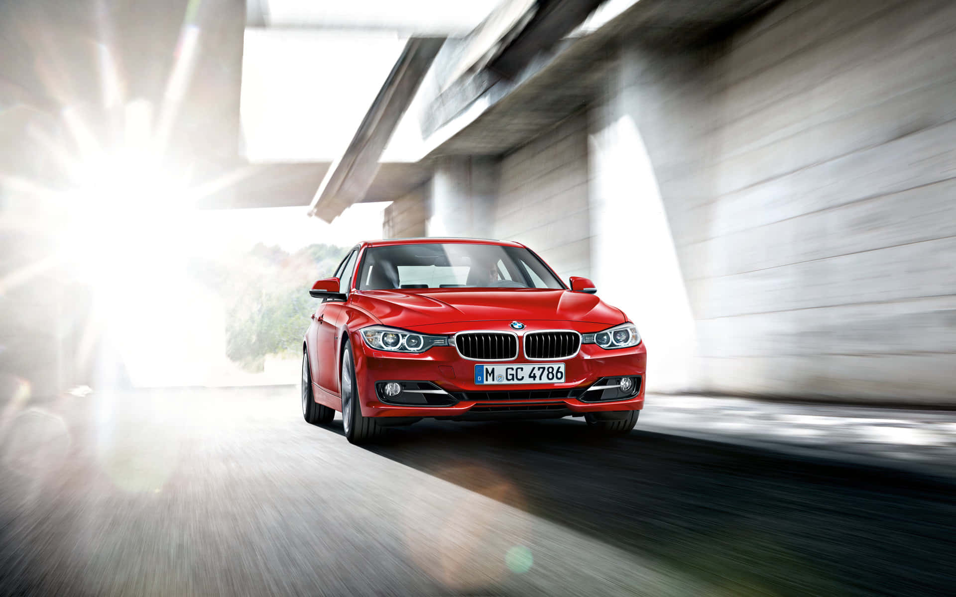 Bmw 3 Series - A Red Car Driving Down A Road Background