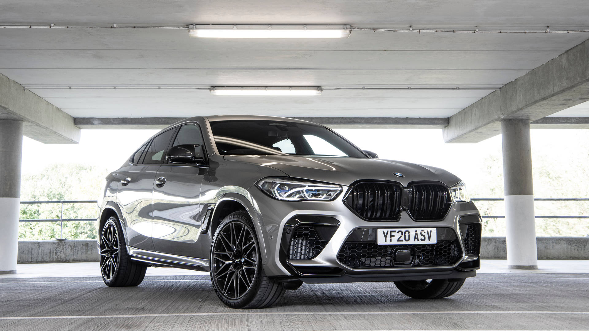 Bmw X6 M In A Parking Lot Background