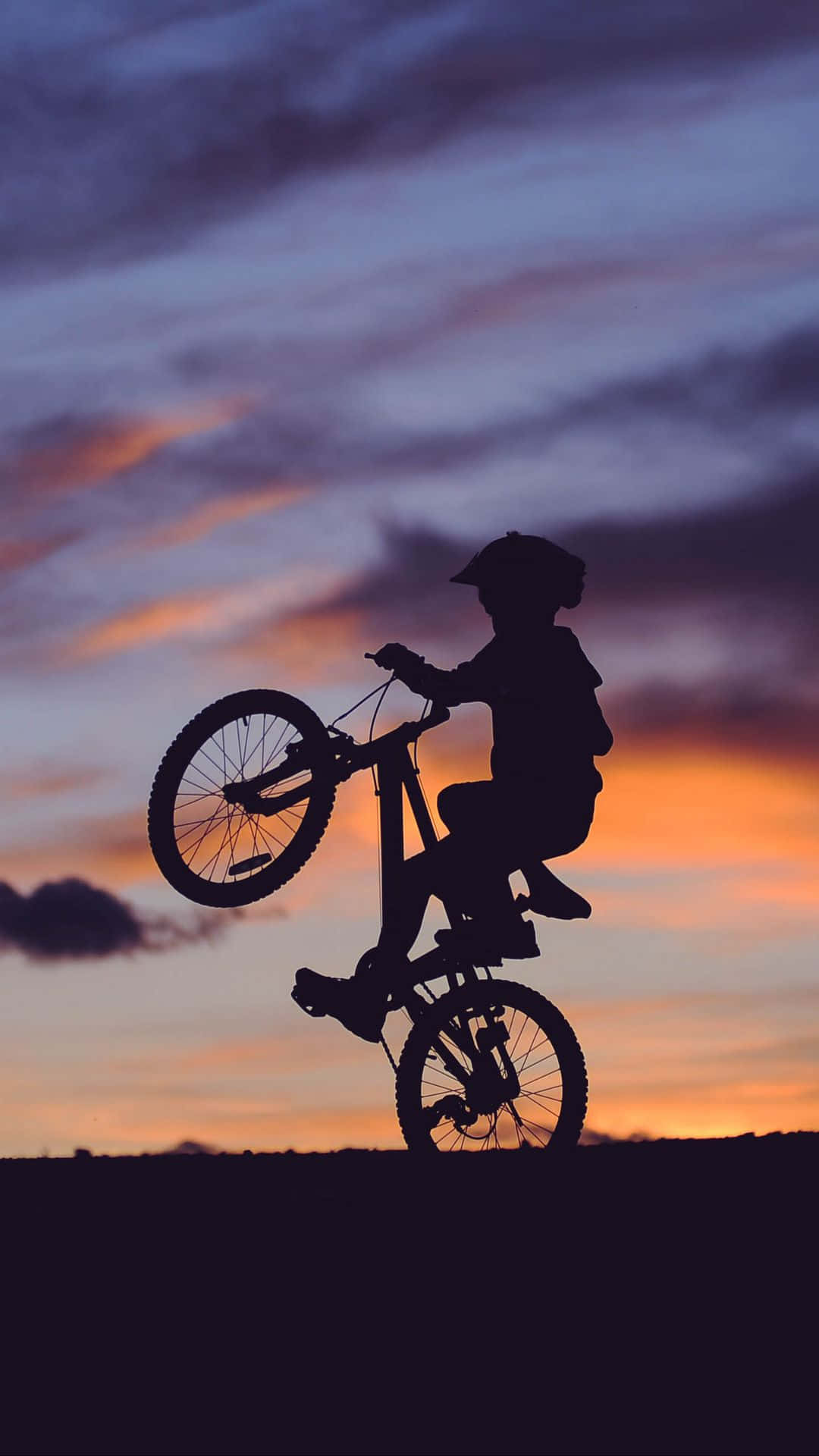 Bmx Biker Showing Off His Latest Trick Background