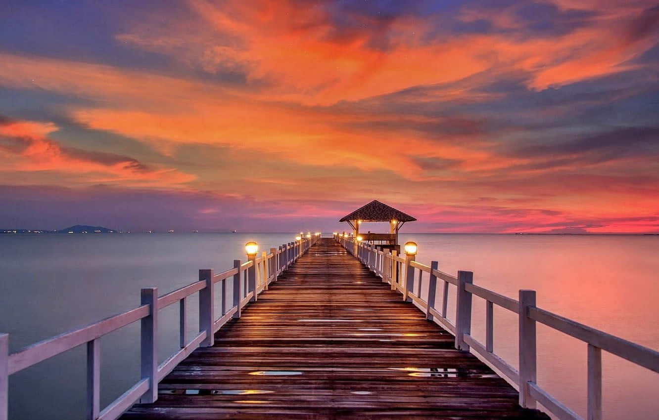 Boardwalk To Hut During Evening Background