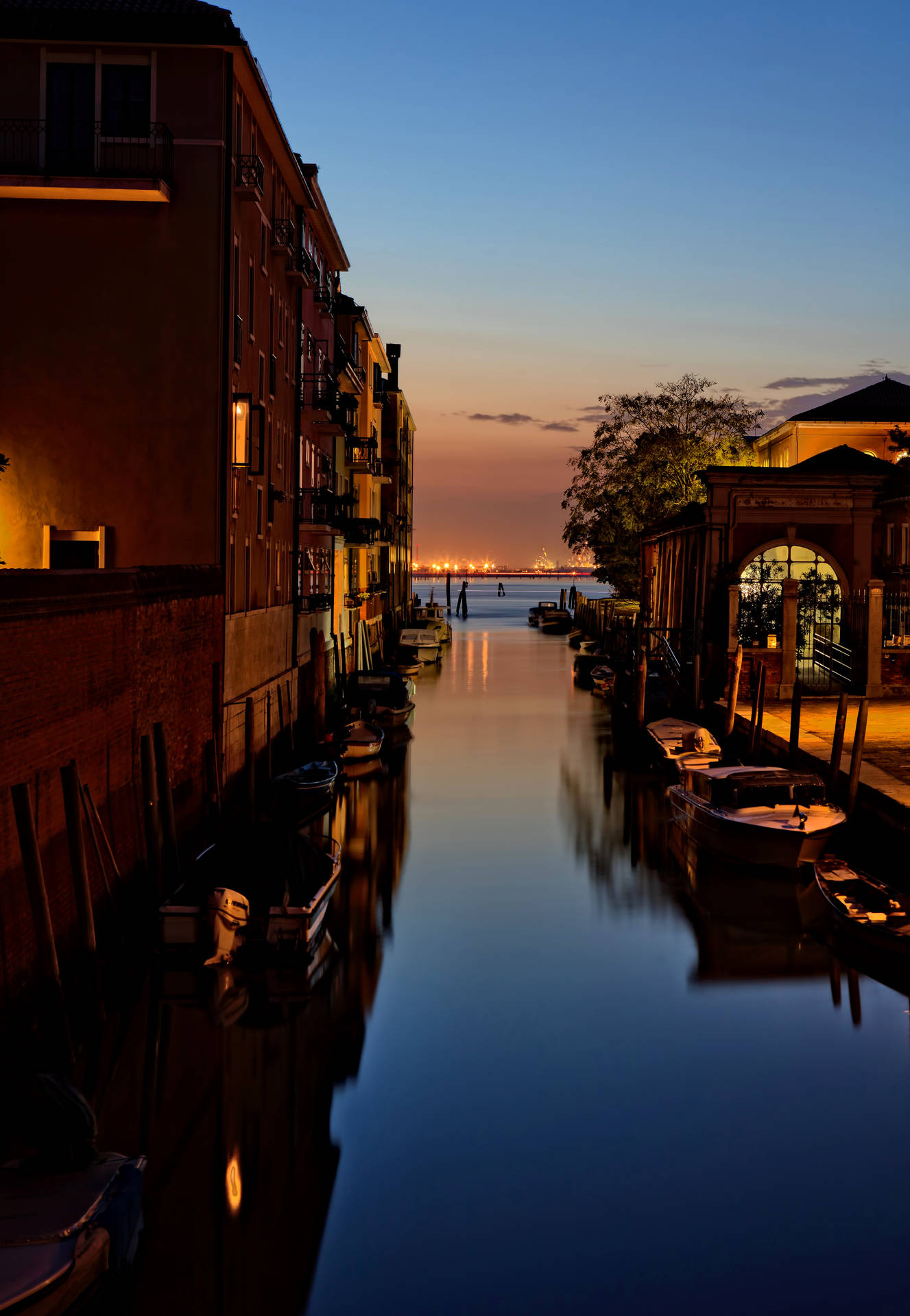 Boat In Canal Beside The Buildings Background