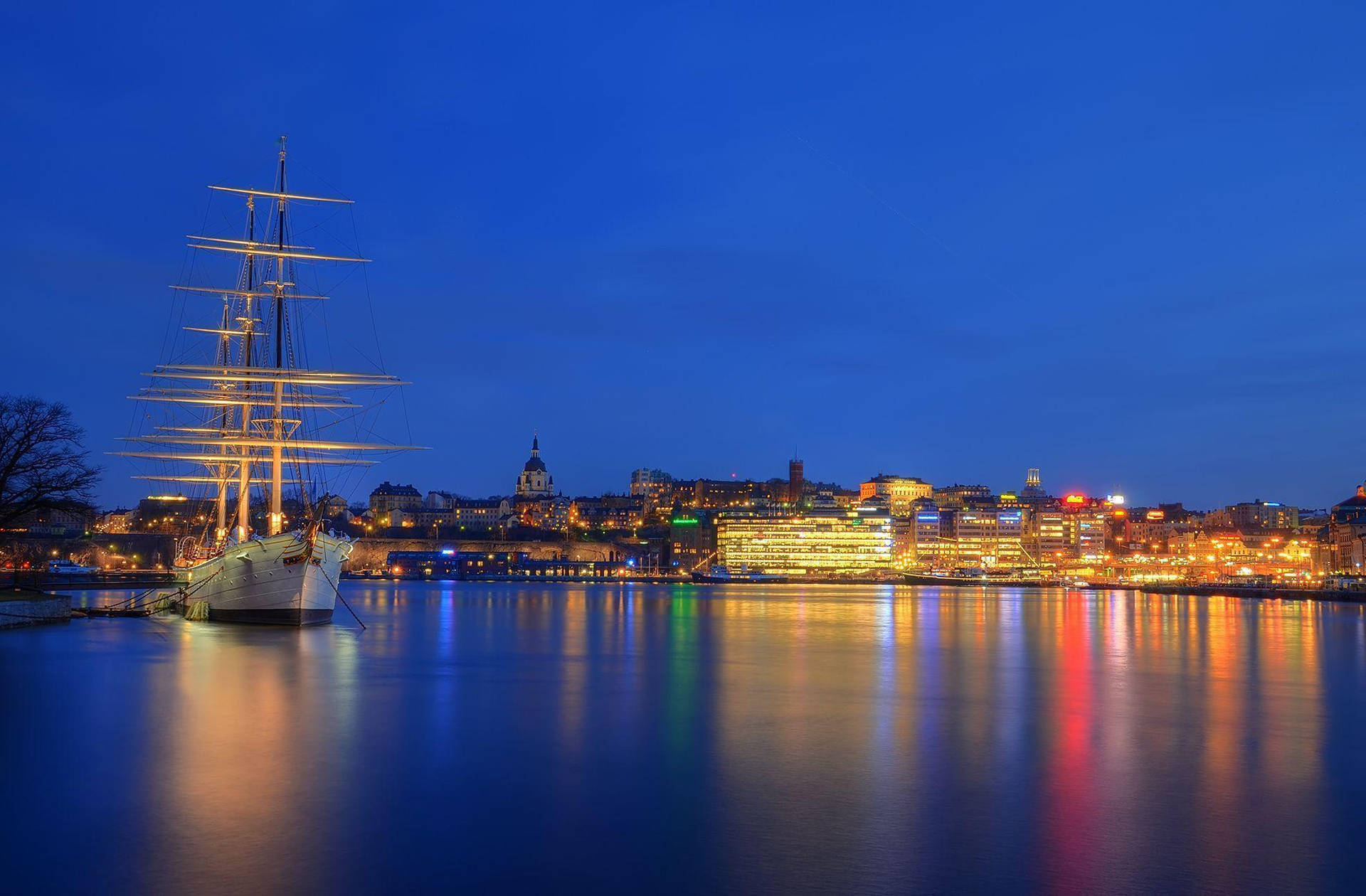 Boat In Stockholm At Night Background