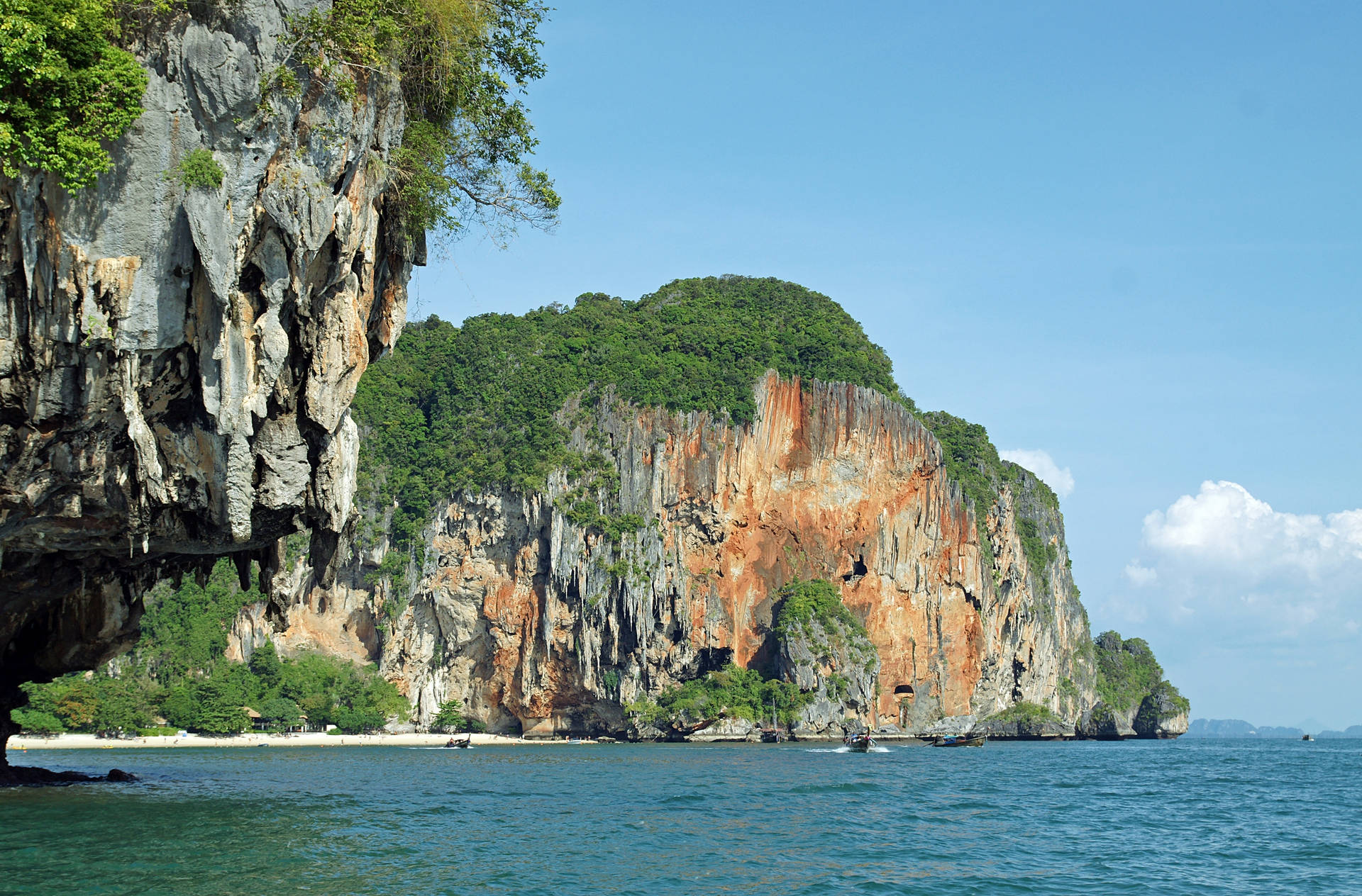 Boat Sailing Against Rock Mountain Background