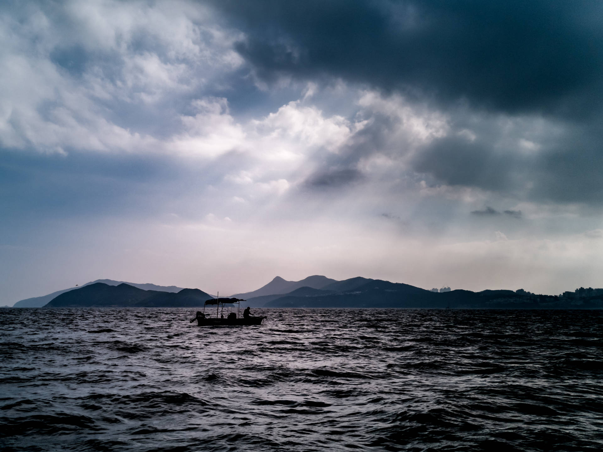 Boat Silhouette On Black Ocean Background