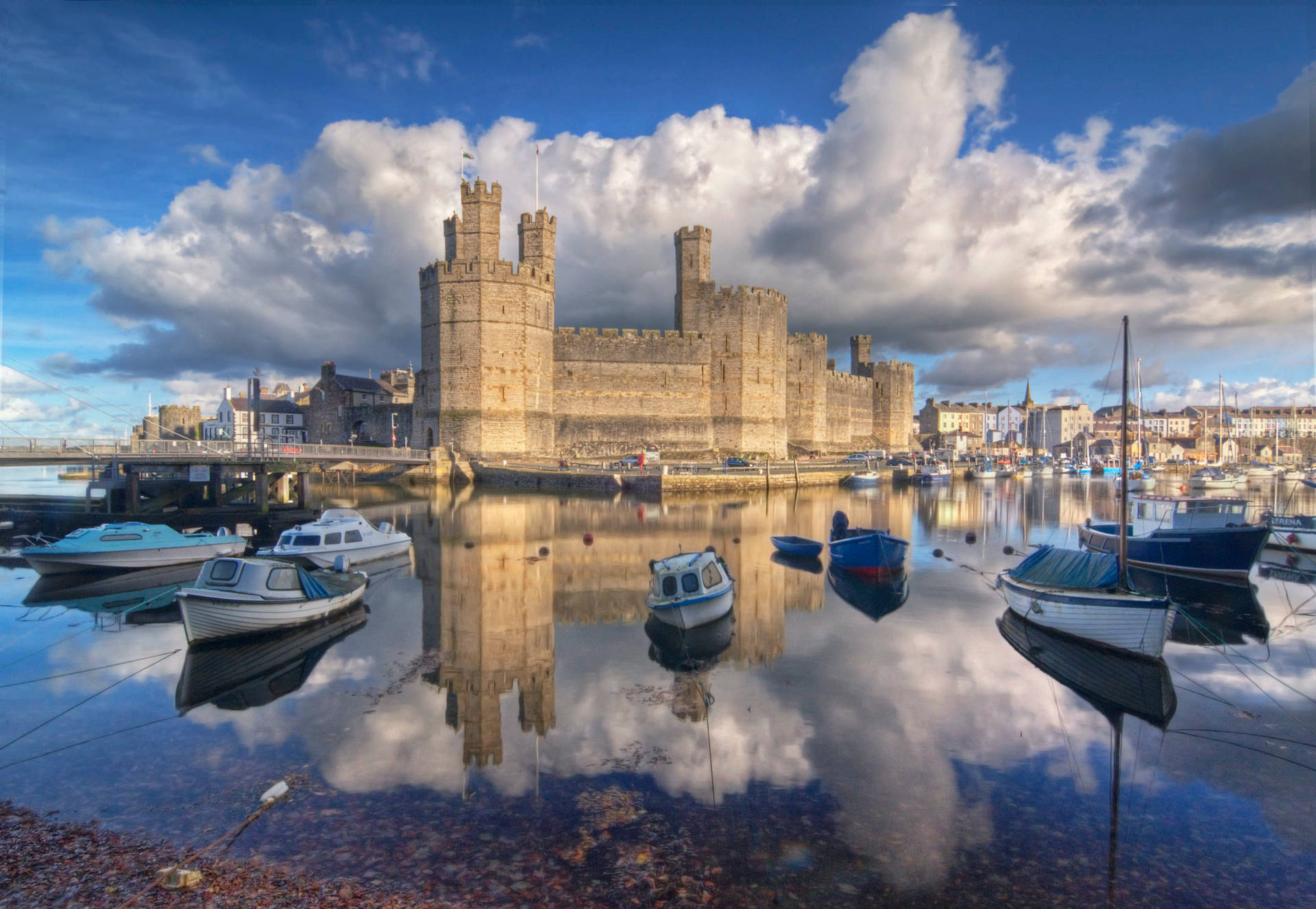 Boats Docked In The Water Near A Castle Background