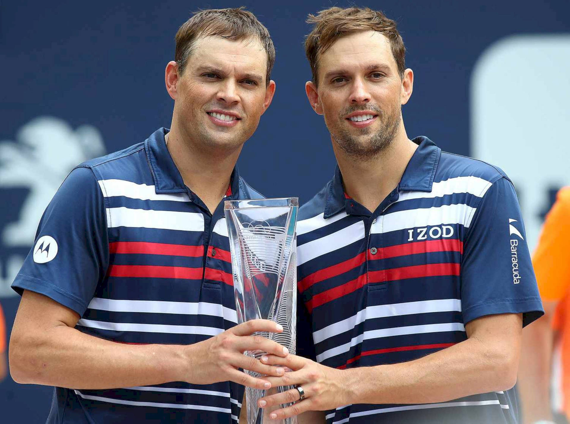 Bob Bryan And Mike Bryan Raise Their Trophy In Triumph Background