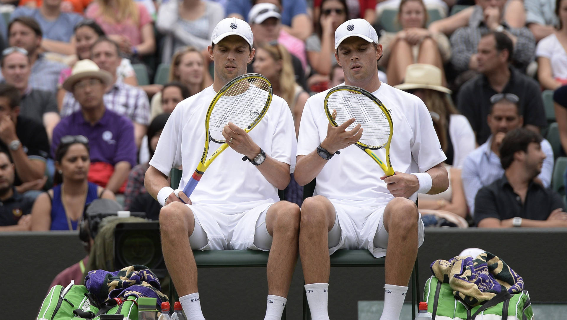 Bob Bryan And Mike Inspecting Rackets