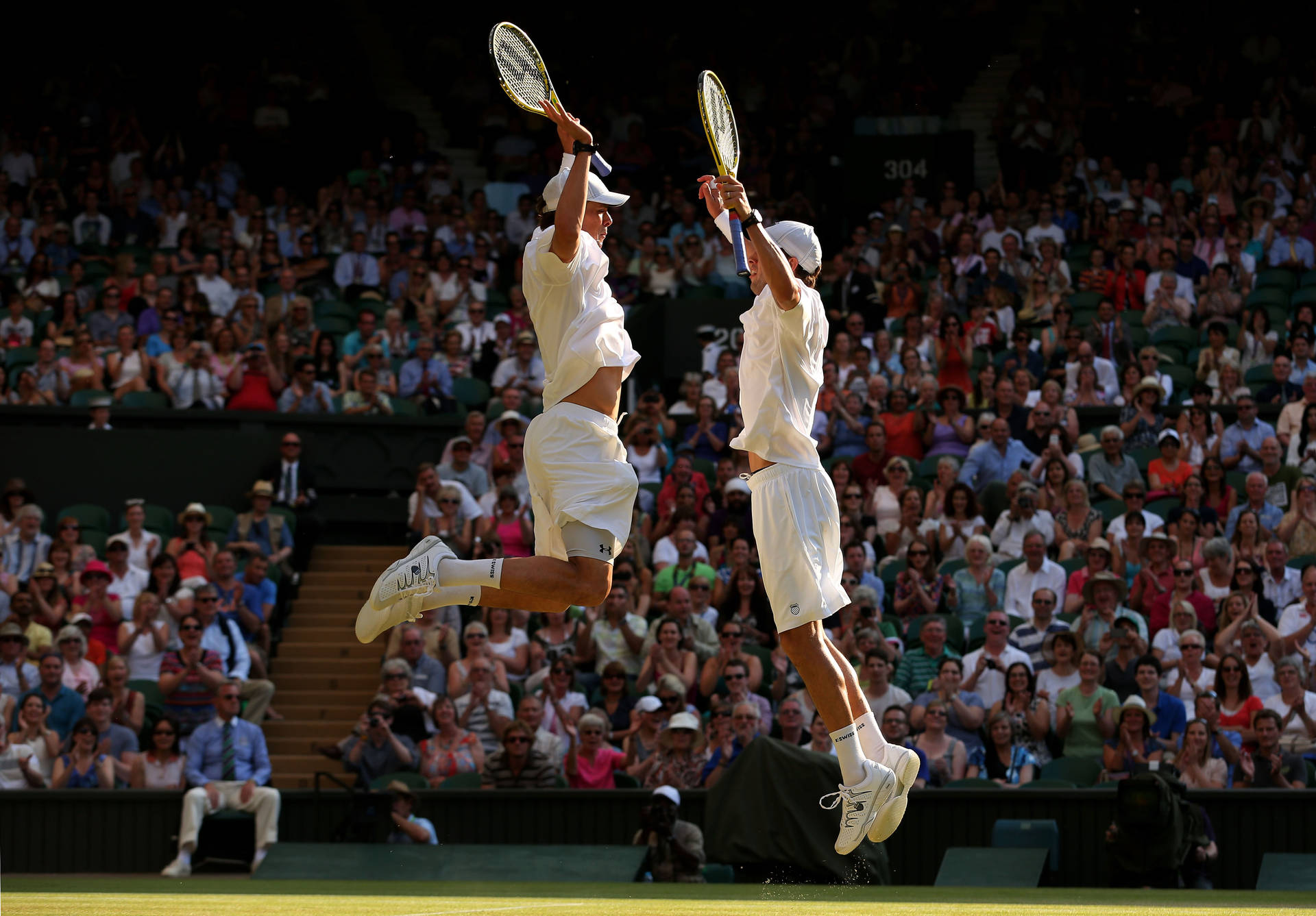 Bob Bryan Jumping With Mike Bryan Background