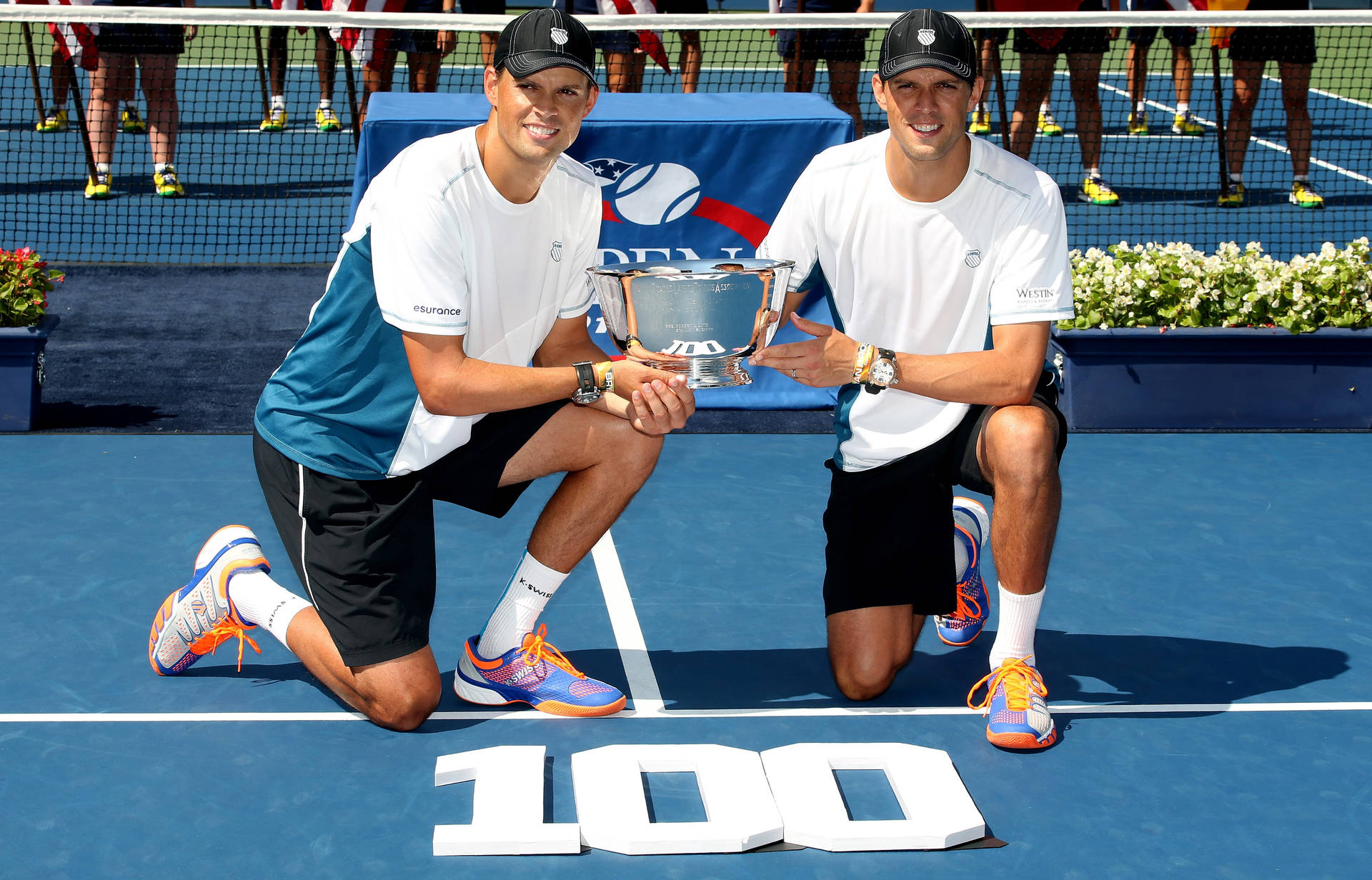 Bob Bryan Showcasing Championship Trophy Background