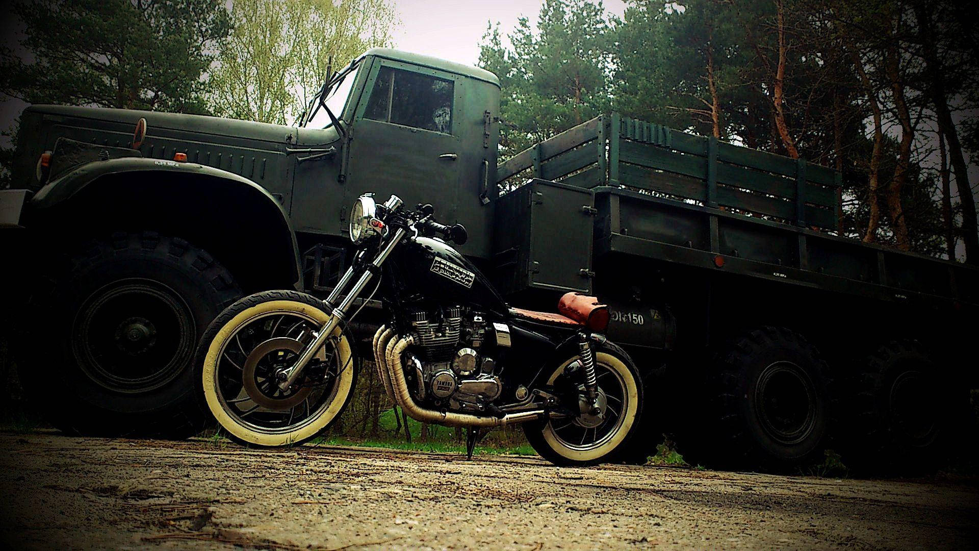 Bobber Motorcycle By An Army Truck Background