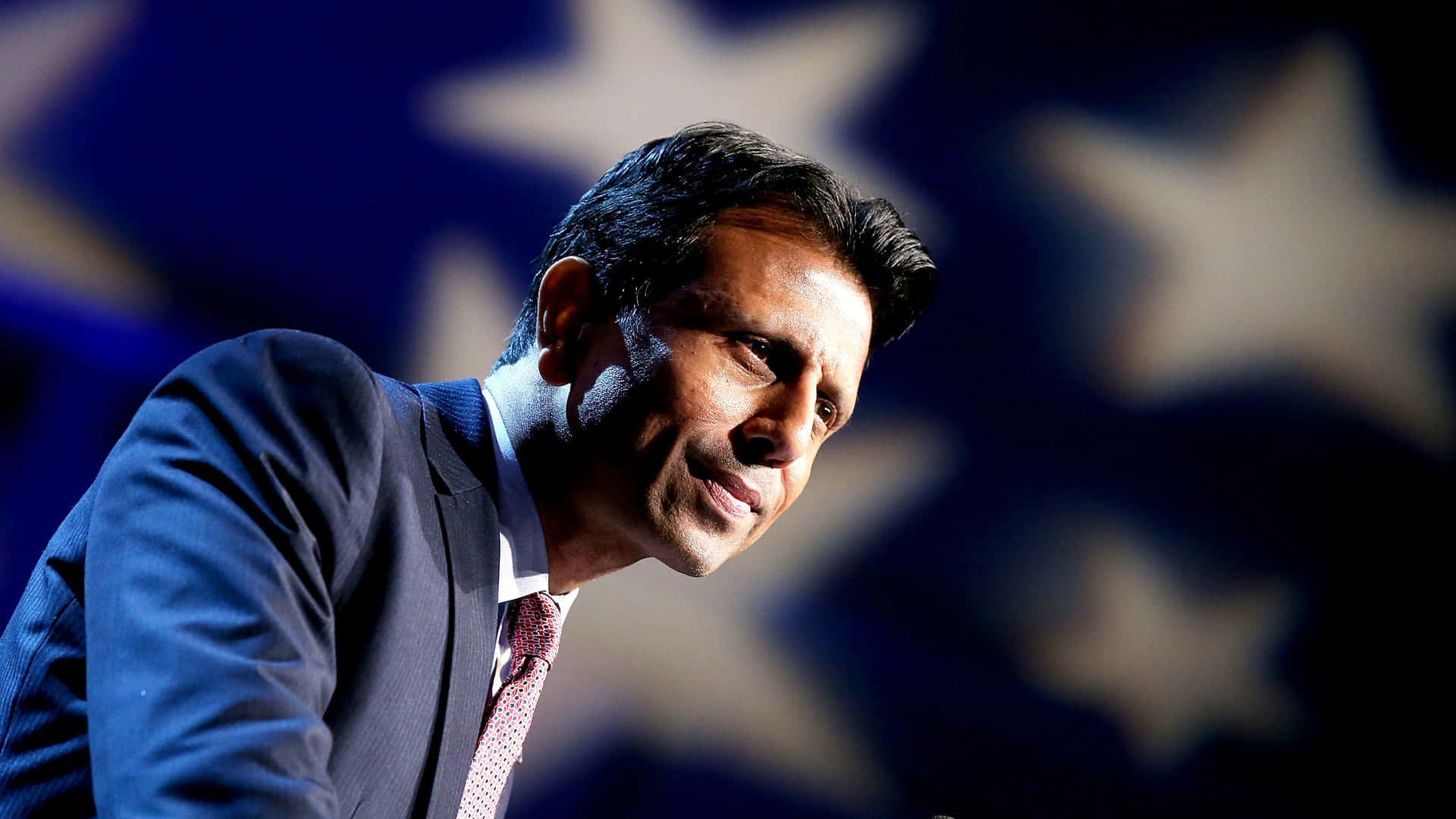 Bobby Jindal Standing Proudly With American Flag Background