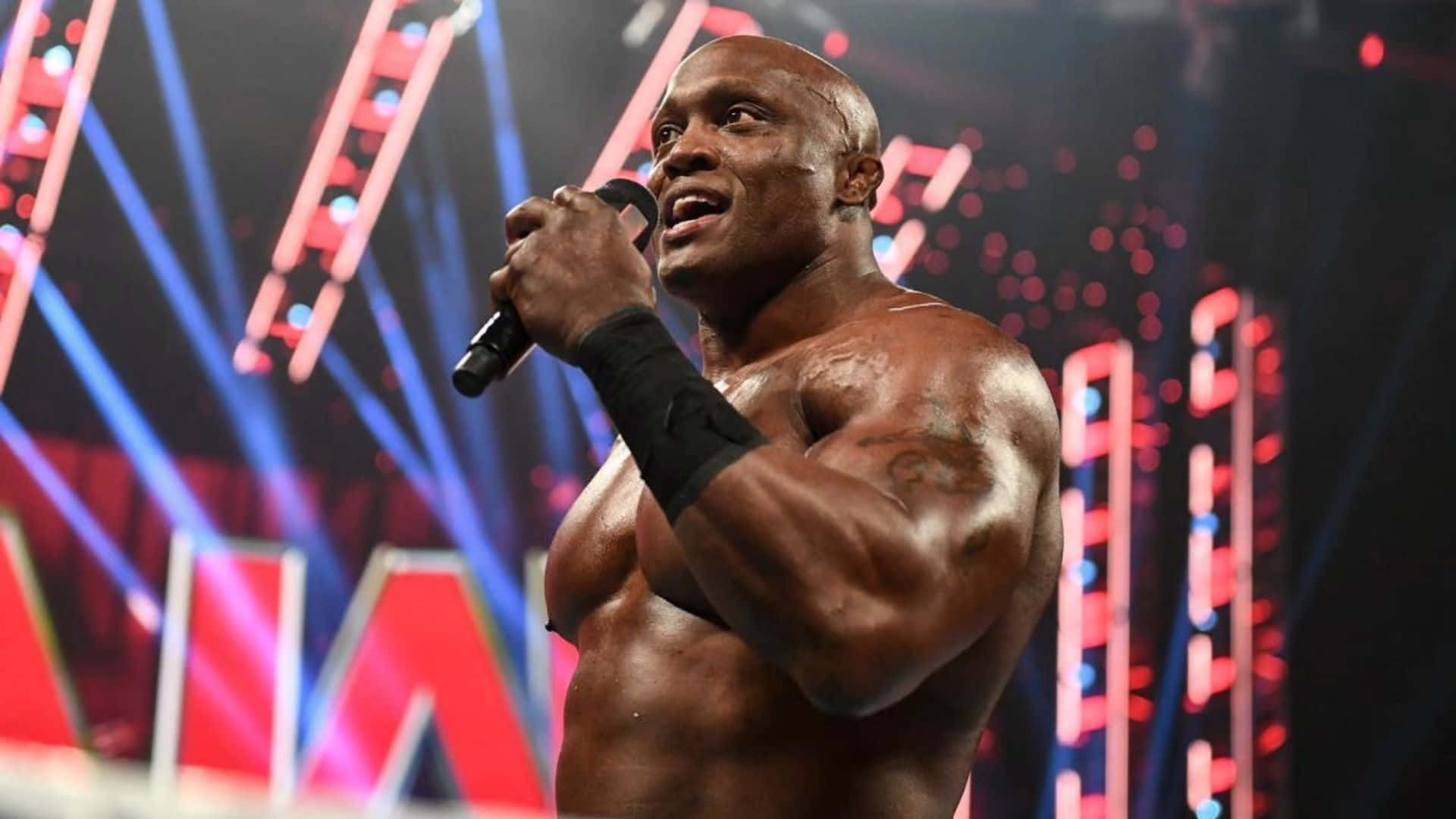 Bobby Lashley Holding A Microphone Background
