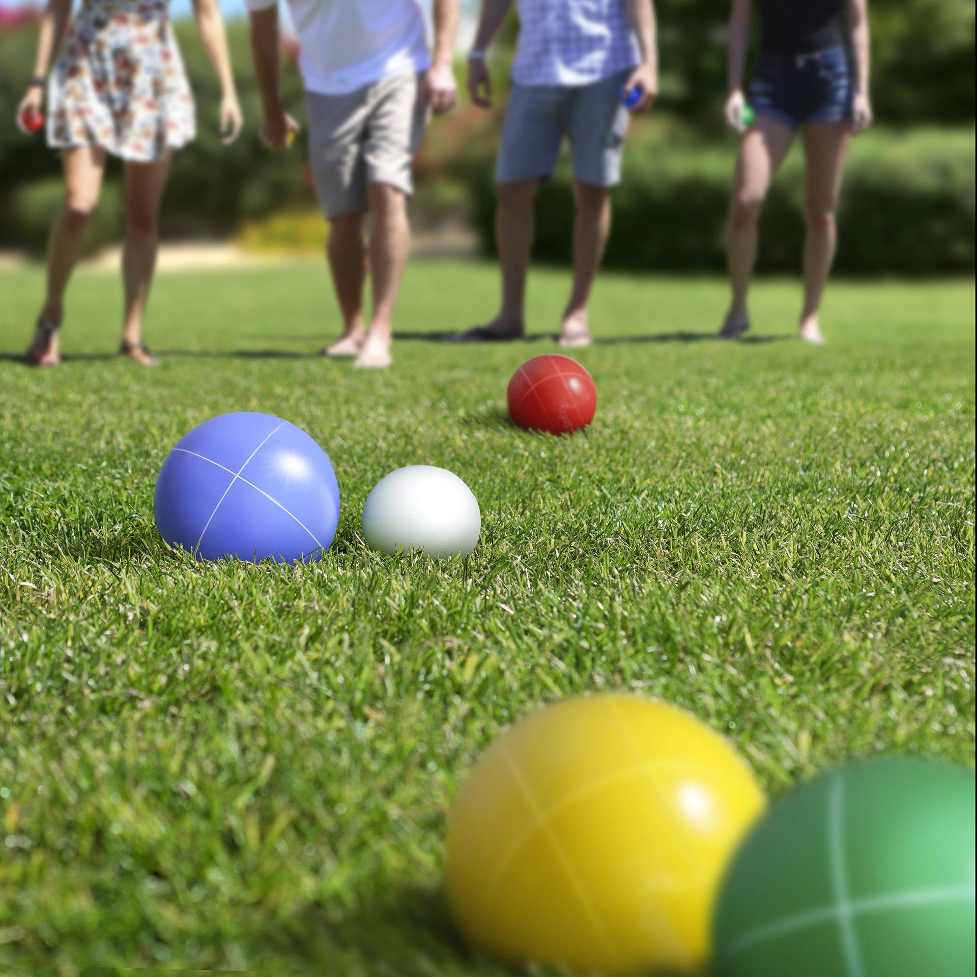 Bocce Ball On Grass With Players' Feet Background