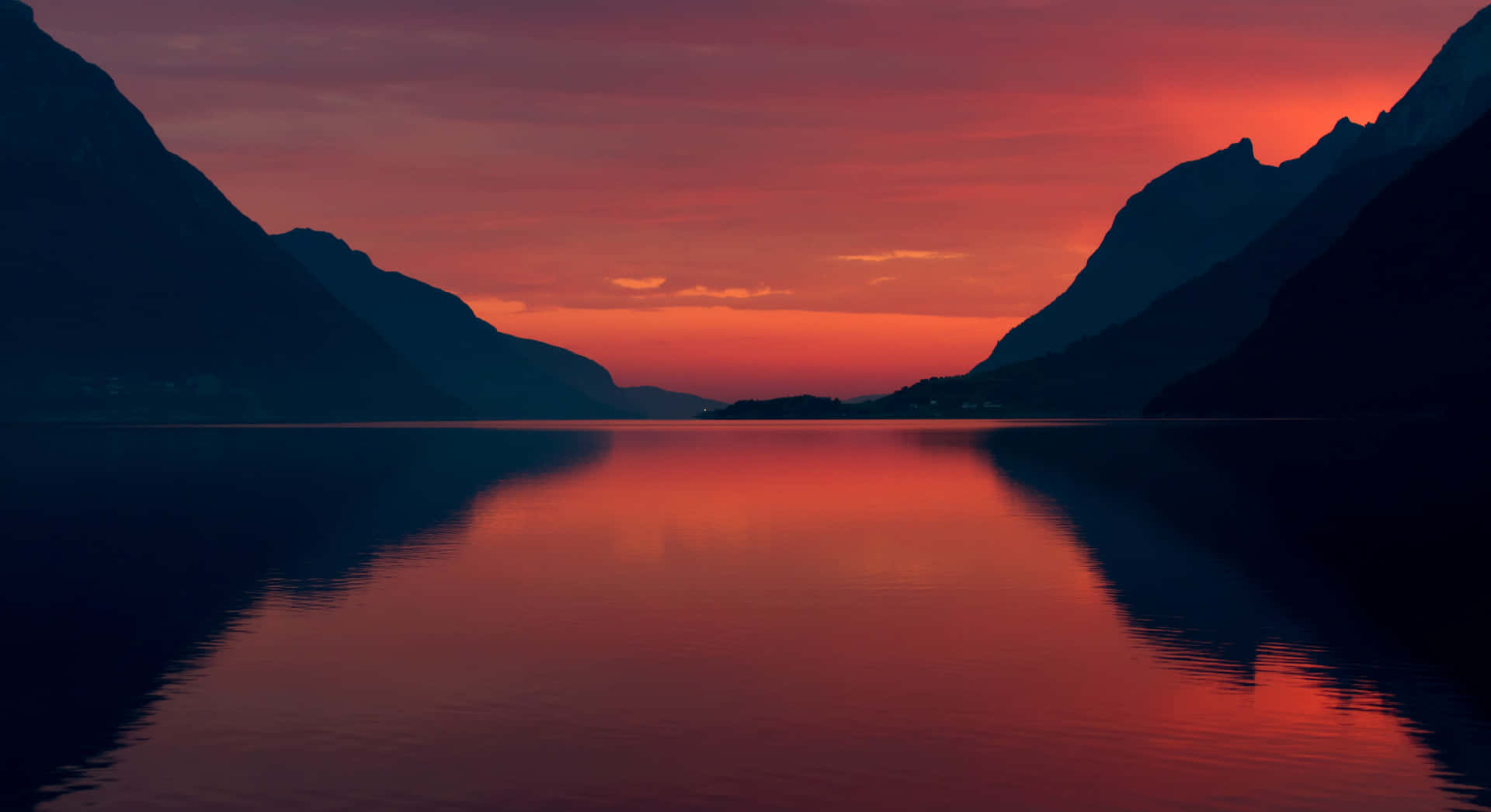 Body Of Water With Mountains Under Evening Sky